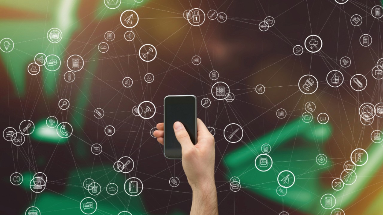 Hand holding smartphone with icons collection