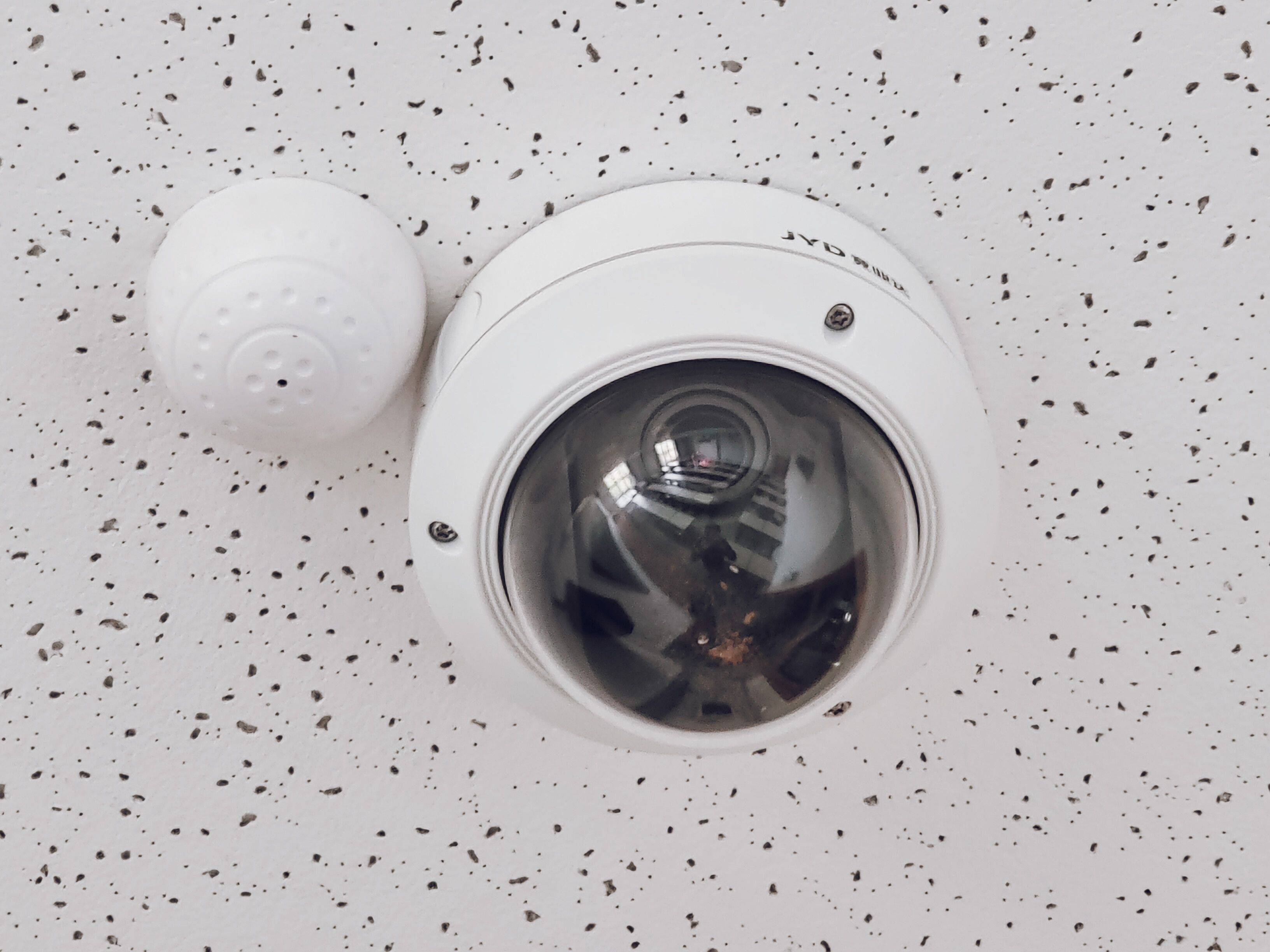 close-up-of-a-round-dome-surveillance-camera-installed-on-a-speckled-ceiling-for - david-yu (pexels)