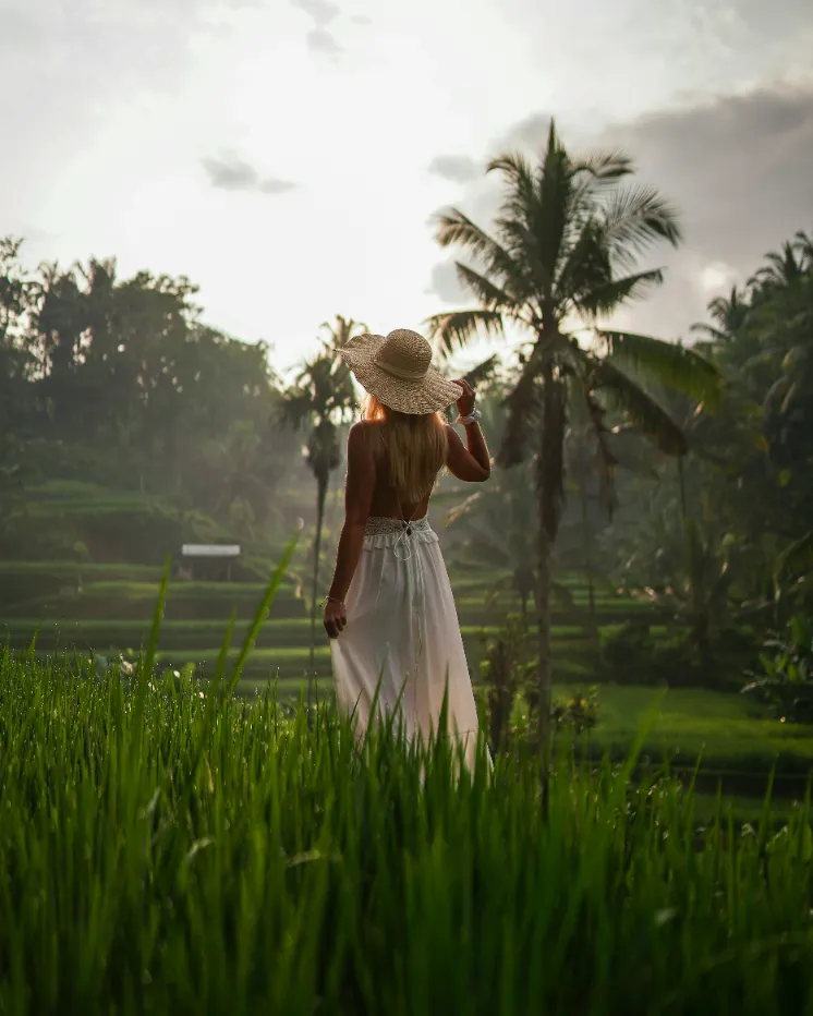 a woman in a red dress swinging from a rope