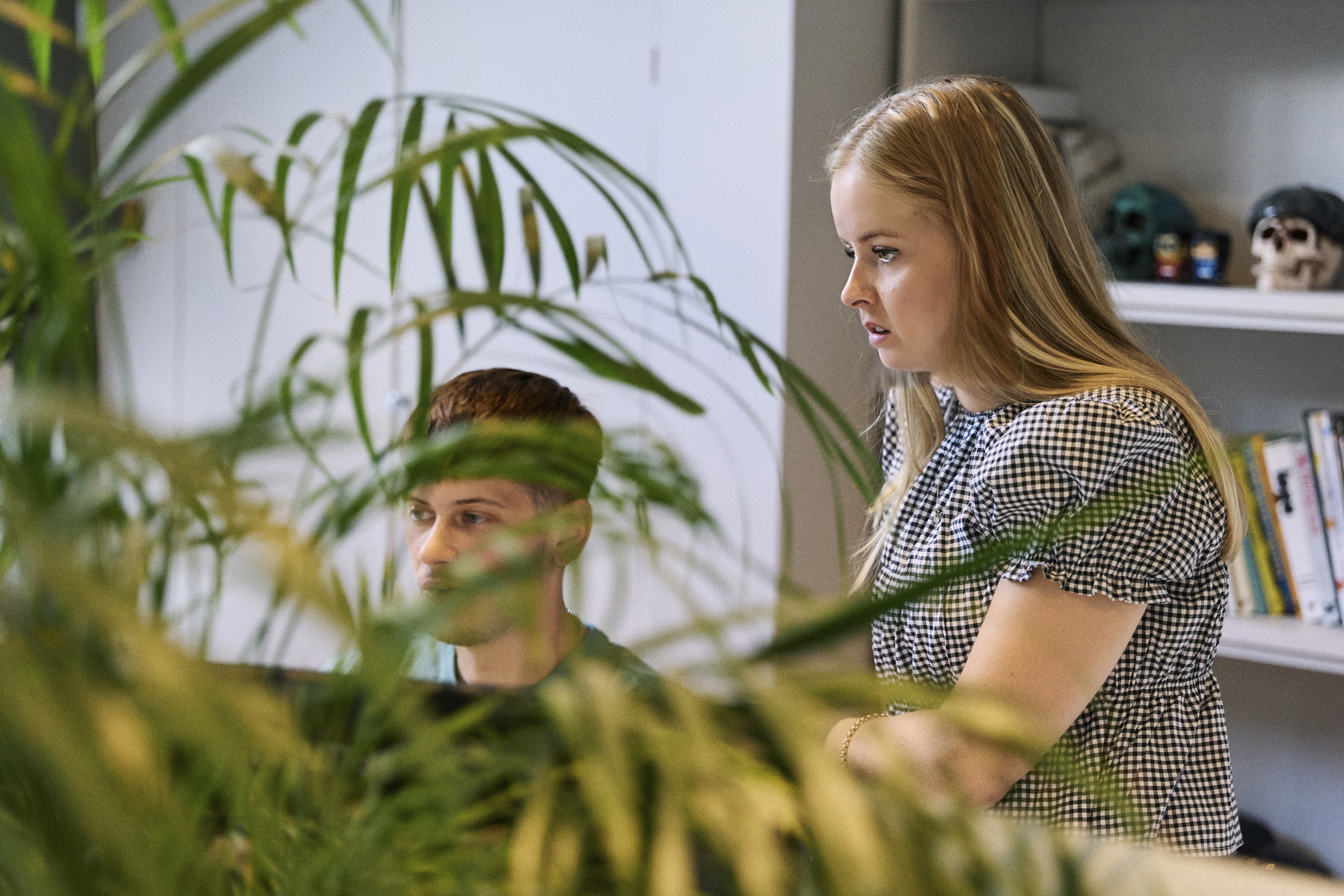 Person in a white off-shoulder top using a MacBook laptop, with text overlay 'What's new in digital?' and the fabrica® logo in the top corner.