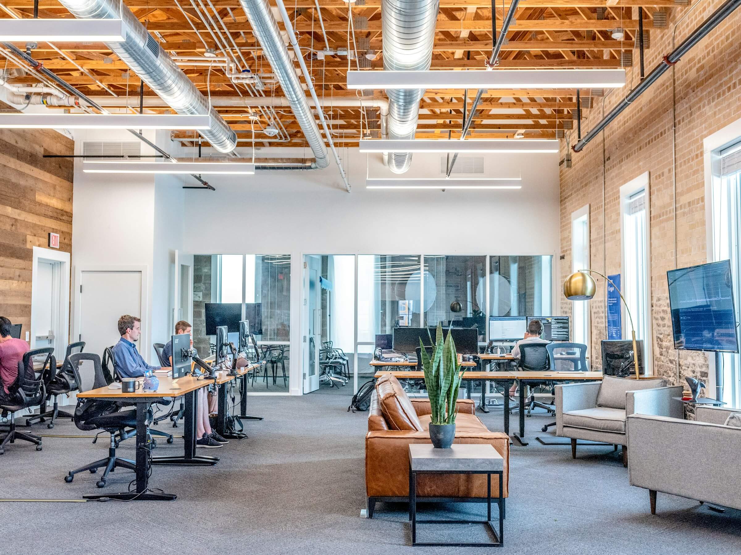 Bright open-plan coworking space with high ceilings and exposed structure