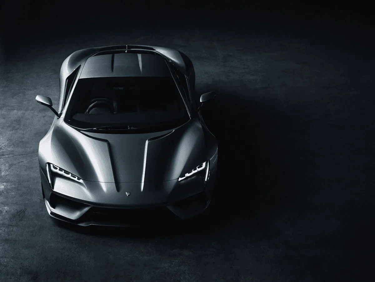 Silver sportscar from above, dark background
