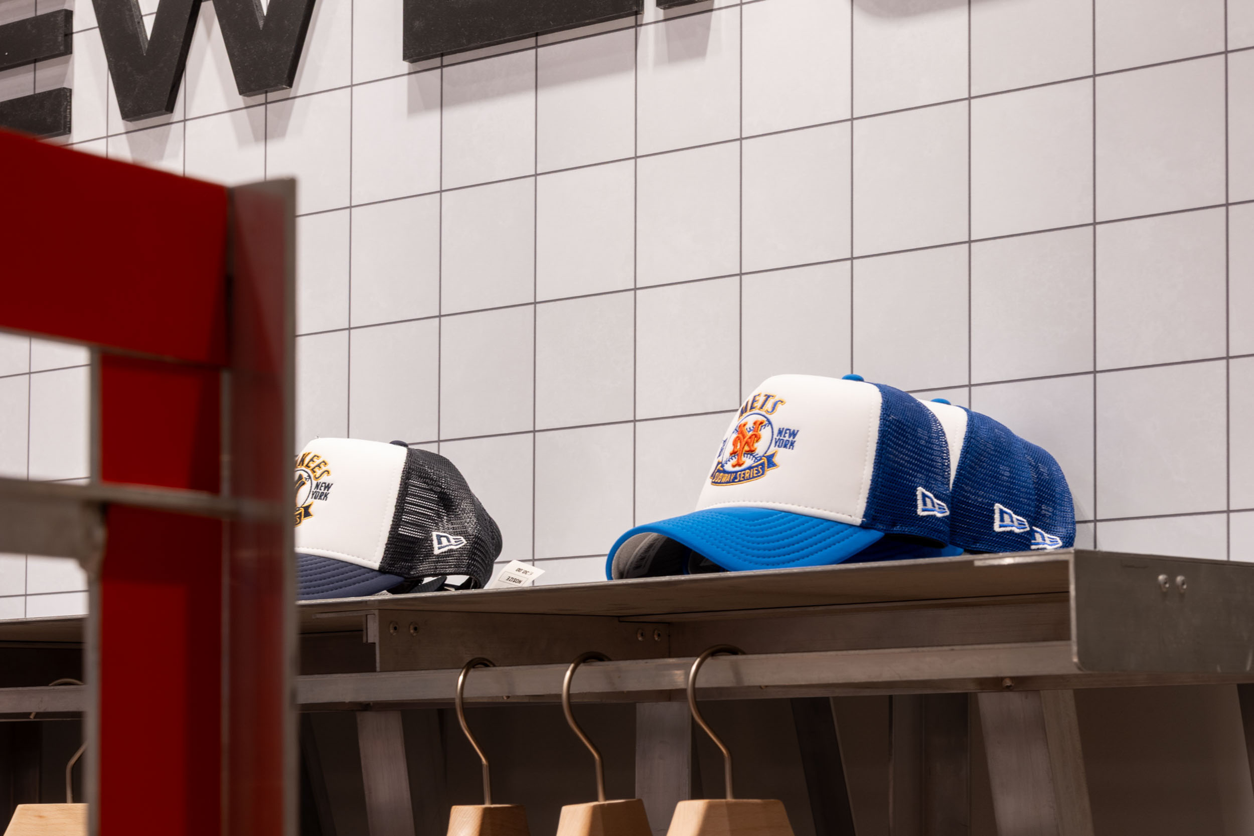 Sportswear and cap display within a retail pop-up activation featuring themed visual merchandising, branded fixtures and product storytelling