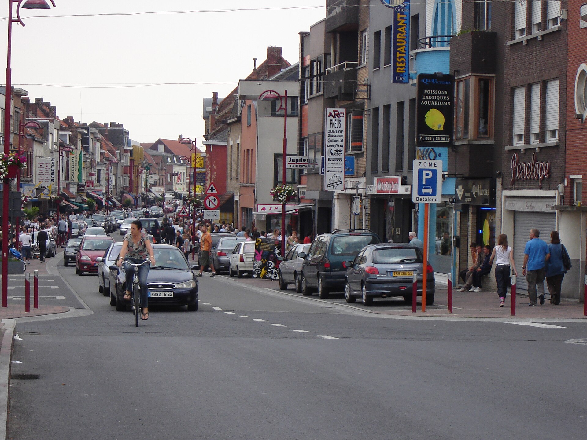 Shops and small businesses lining De Barakken in Menen, West Flanders.