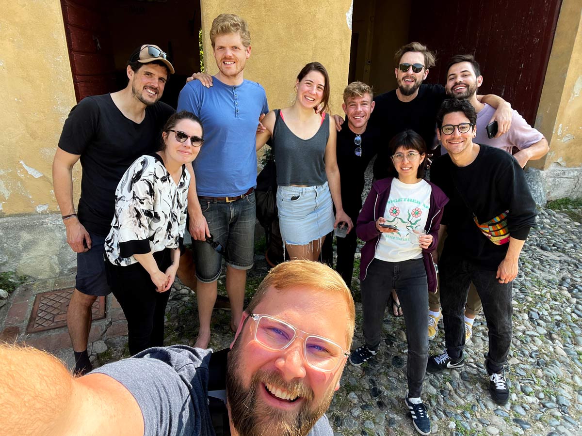 A team of colleagues posing for a photo during a company retreat 