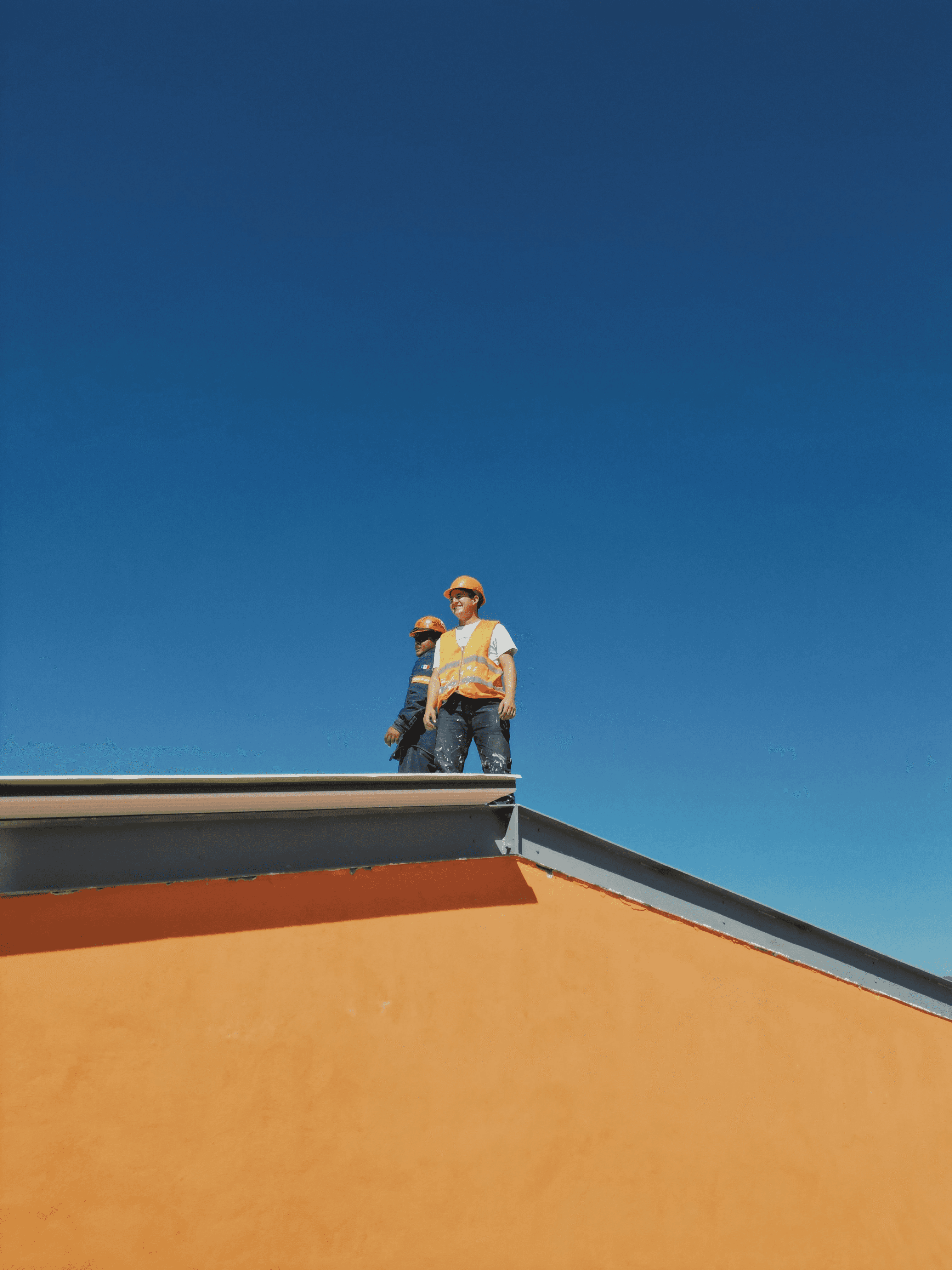 A man standing on top of a skateboard ramp