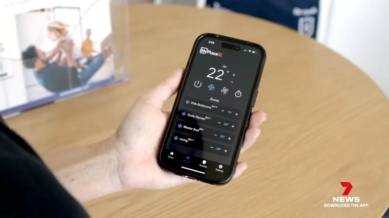 Screenshot of channel 7 news feature showing a smart phone being held with MyPlaceIQ app open