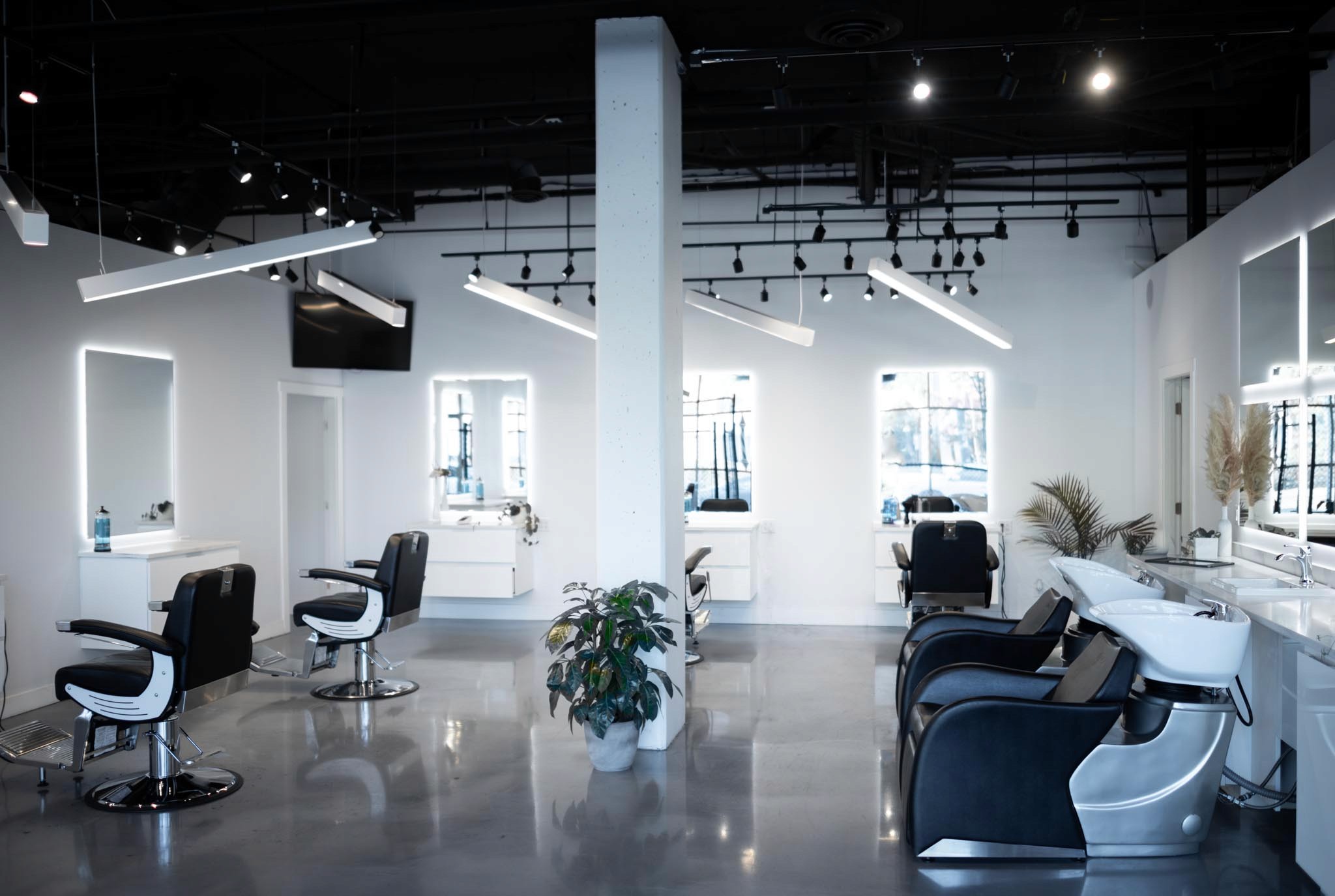 Close-up of a golf ball on green grass with a golf club behind it under a clear blue sky.
