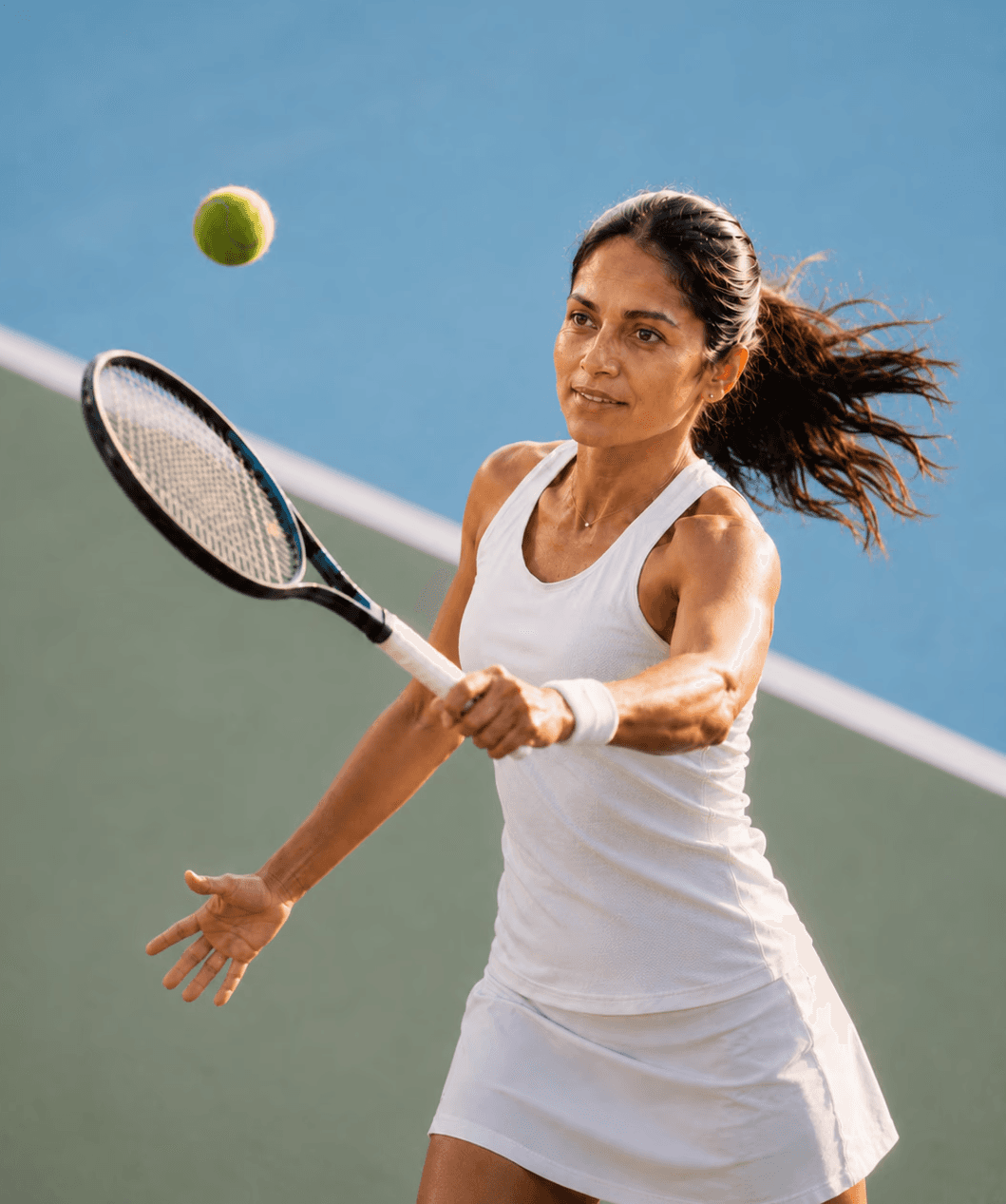 Woman playing tennis on court from above, depicting a high achiever