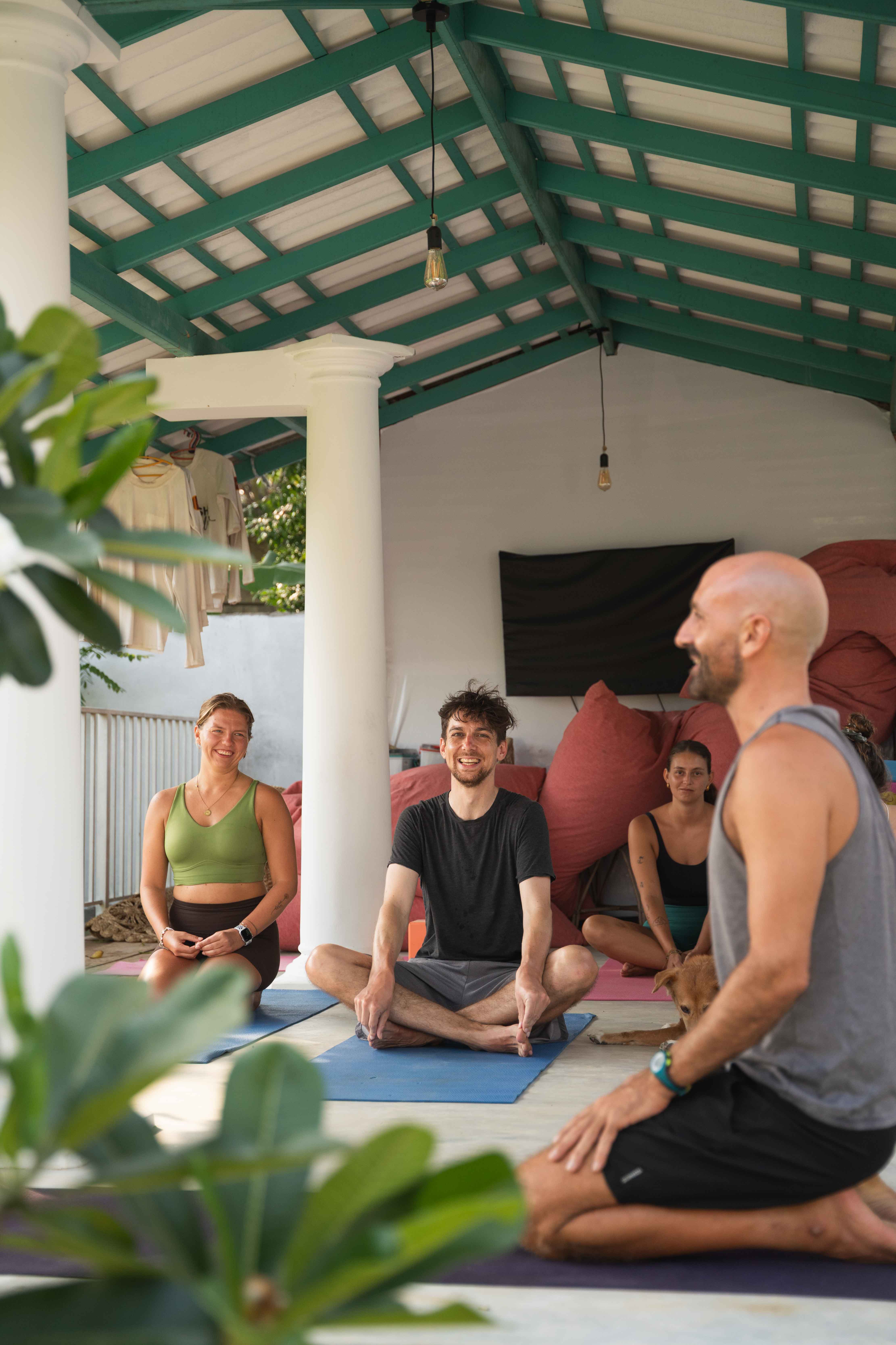 Yoga class with teacher in front and students in the back