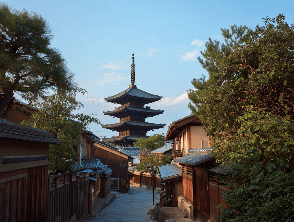 A traditional Japanese street lined with wooden buildings, leading to a tall pagoda against a blue sky.