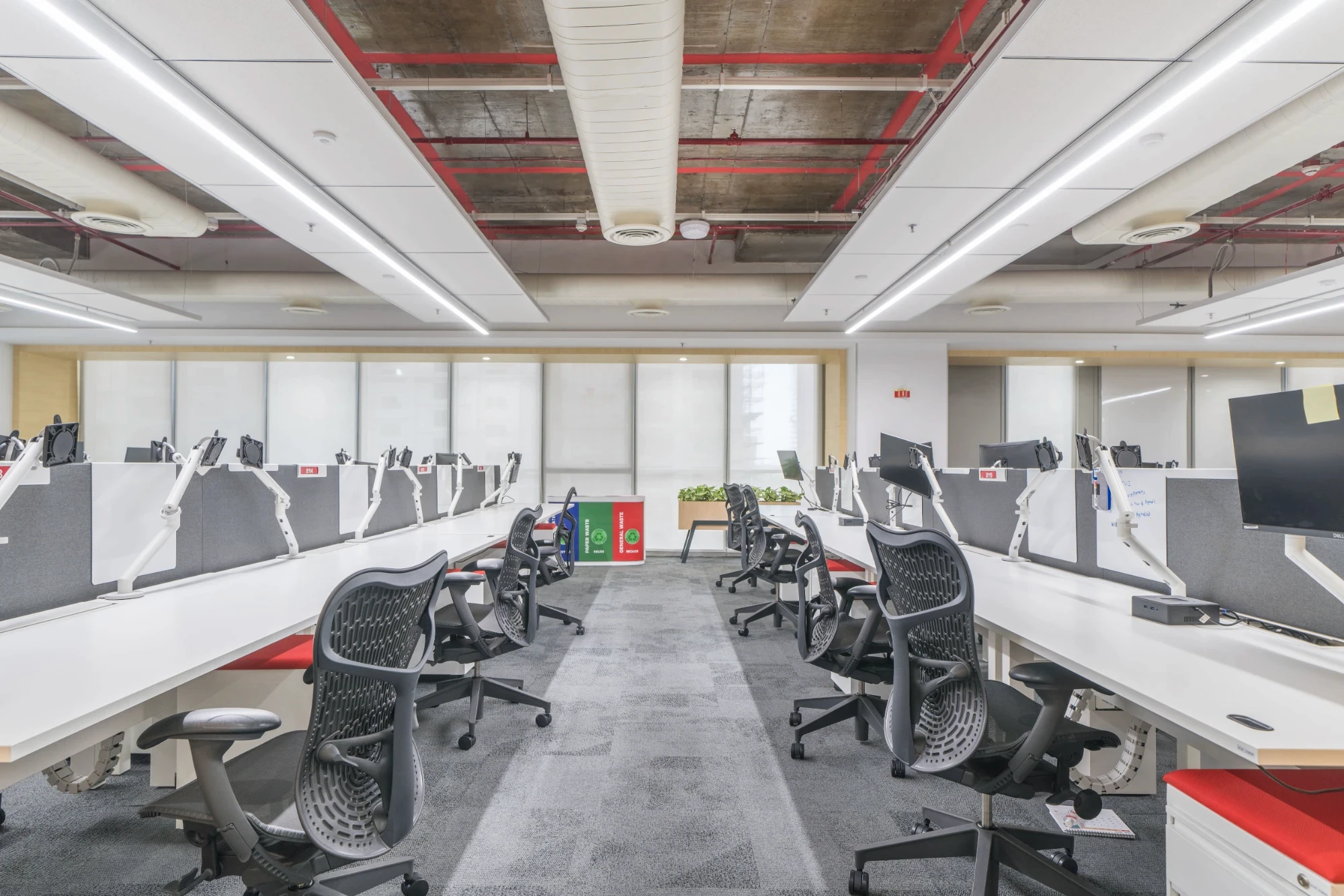 workstation area designed by open grid ceiling and chairs by hermin miller