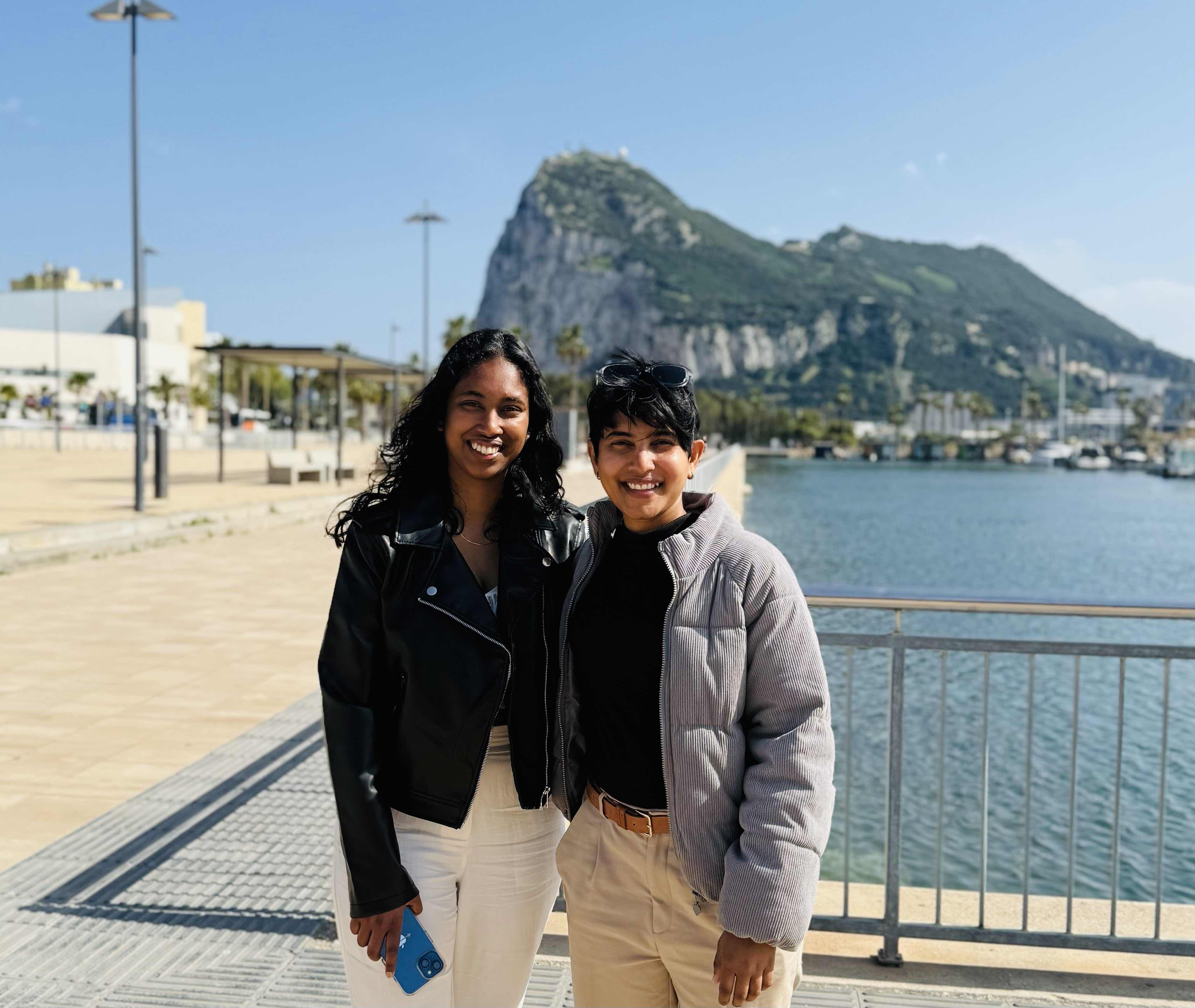 Friends laughing around a campfire in the woods