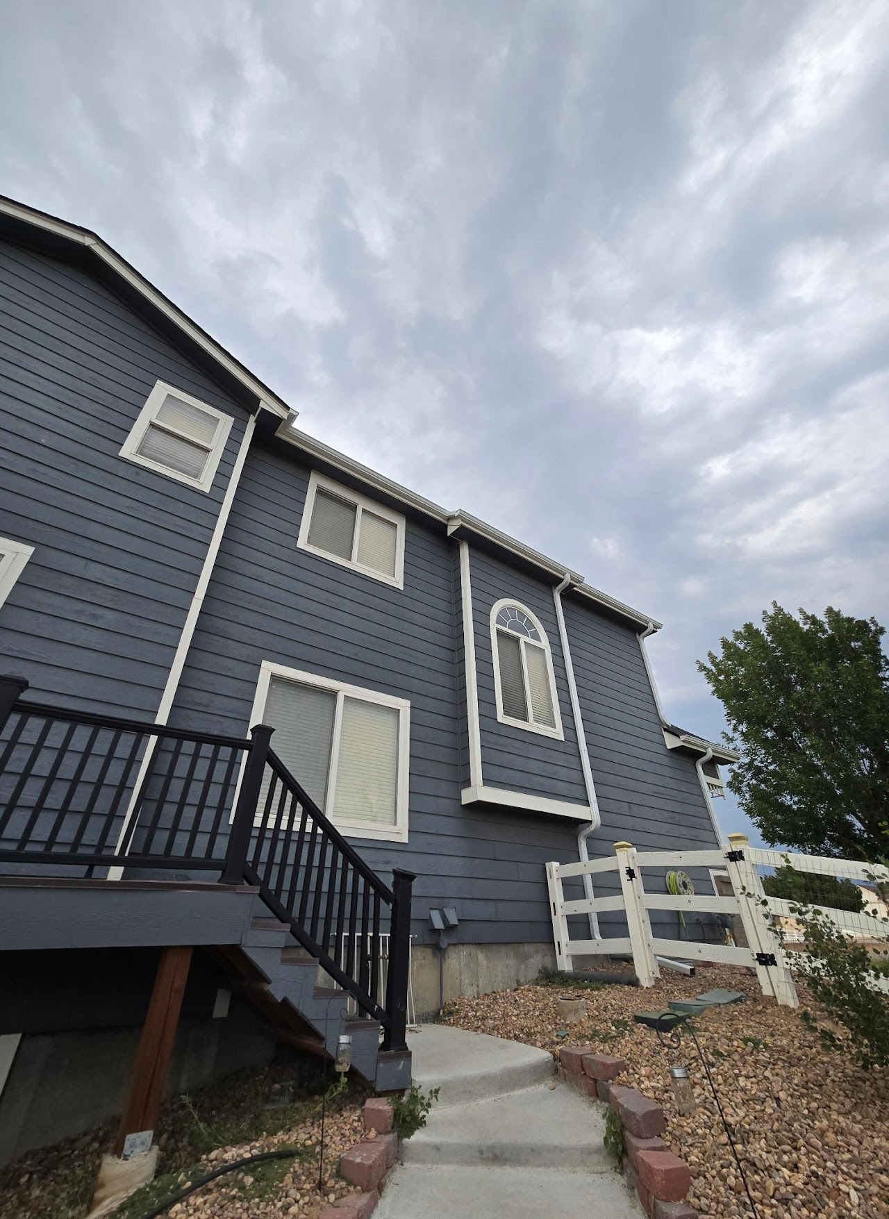 a man in a yellow shirt is working on a roof