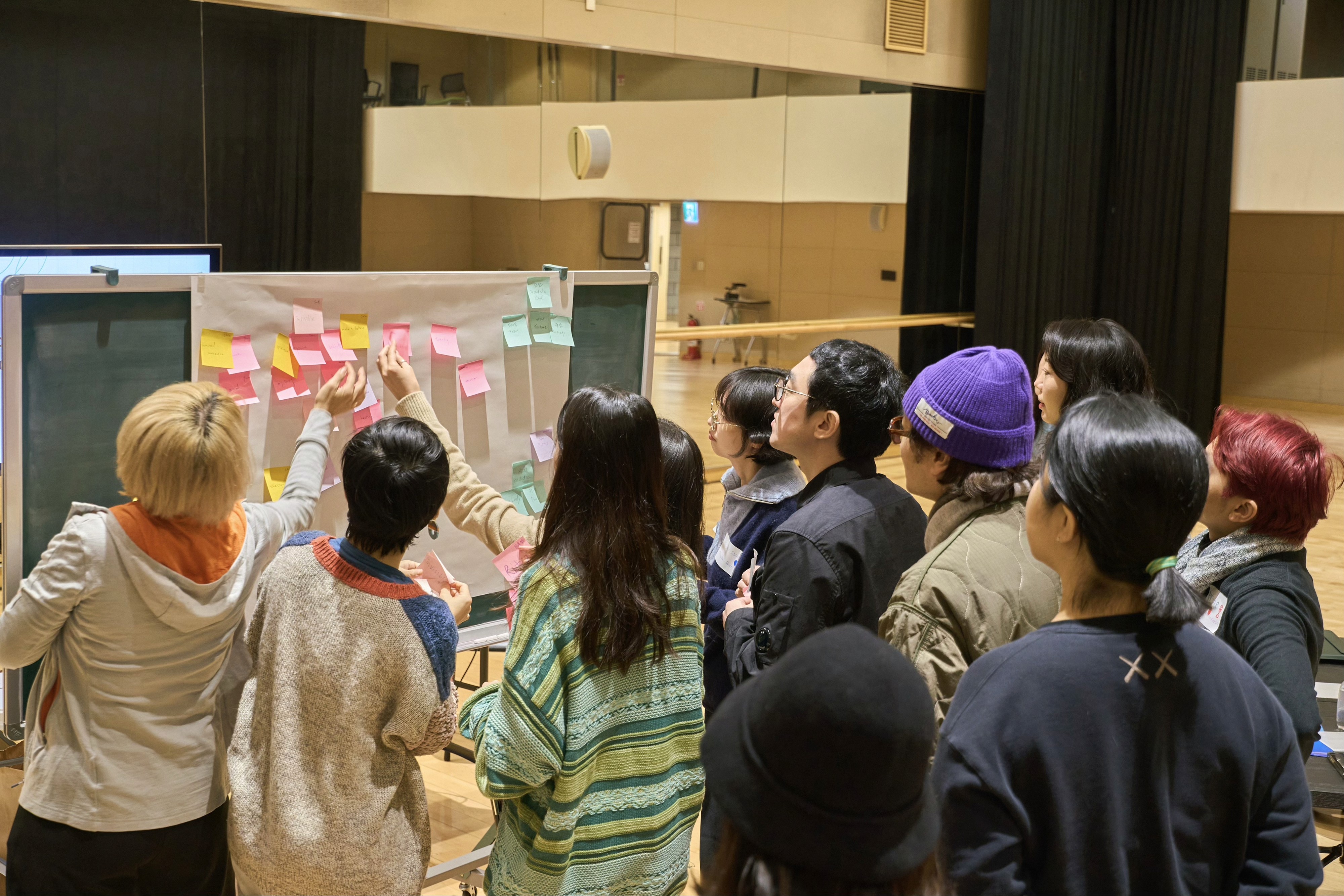 Aerial view of a winding road surrounded by dense green and yellow trees, showcasing nature’s vibrant colors.
