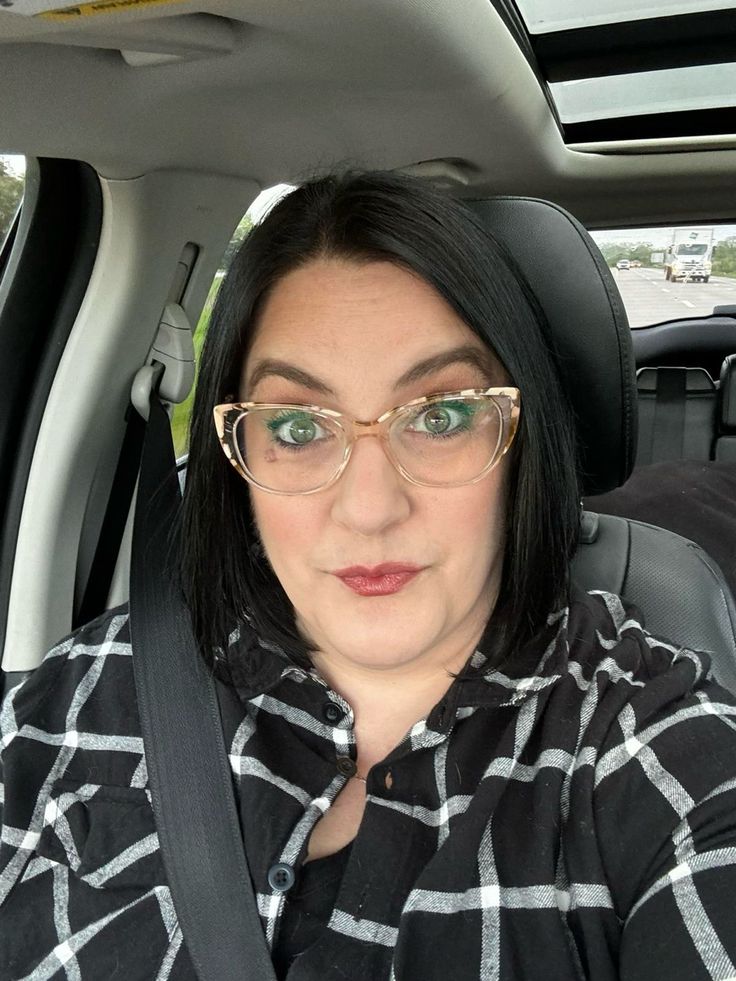 A person in a blue coat smiling