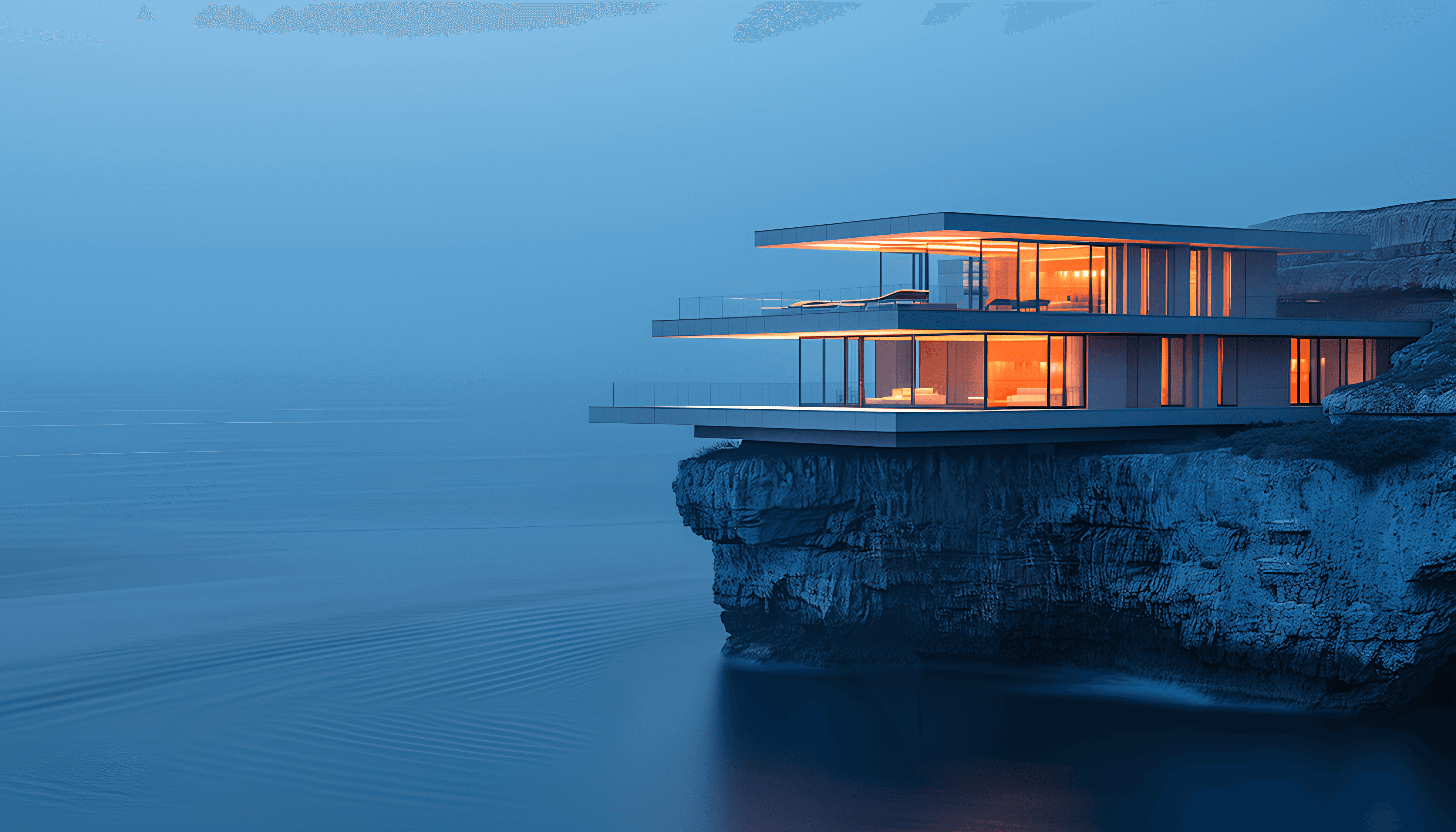 Modern glass house perched on a cliff edge, illuminated warmly against a serene, blue dusk backdrop. Overlooks a calm ocean, conveying tranquility.