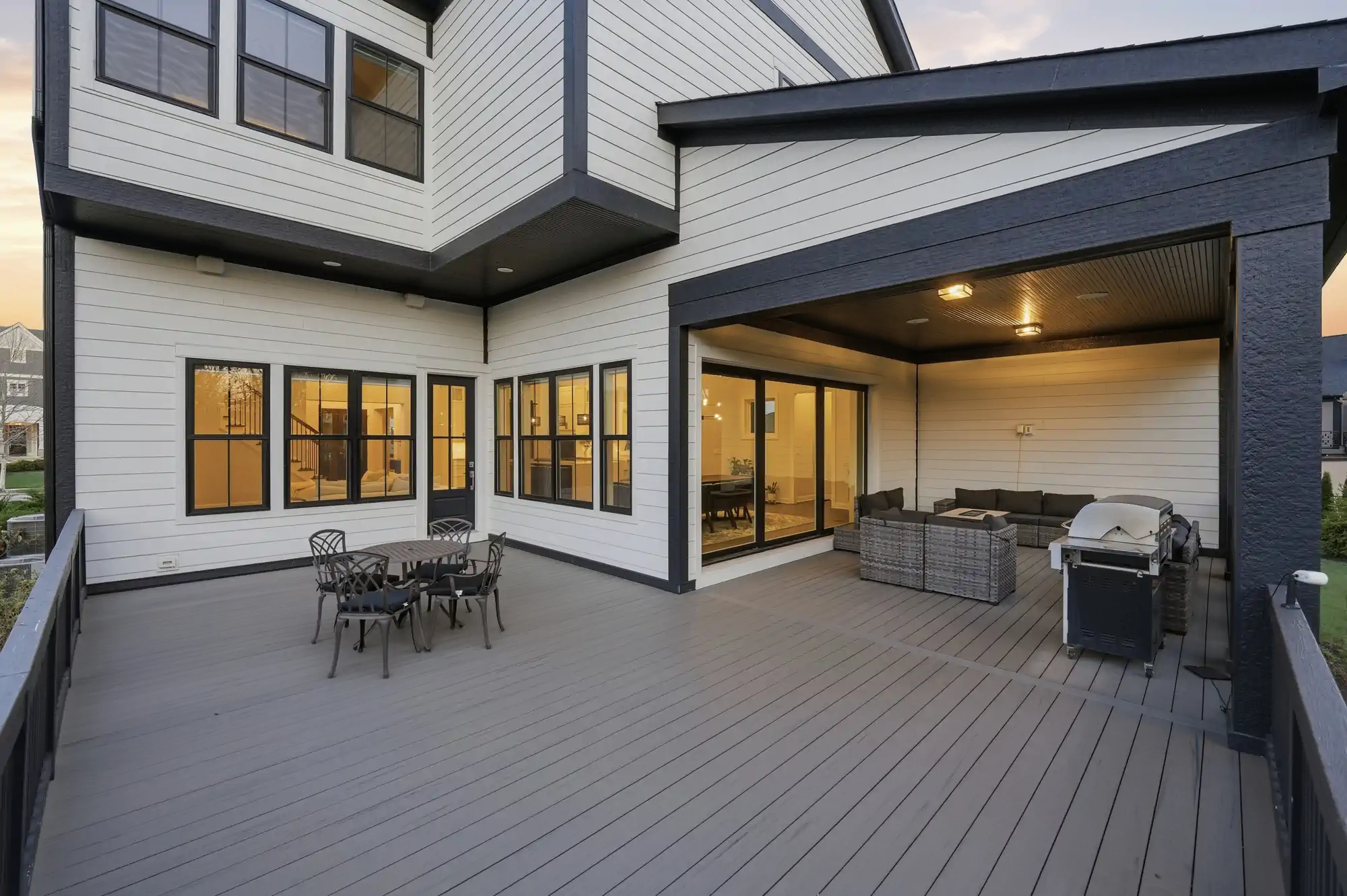 wide angle shot of a deck and indoor/outdoor living space in modern ohio home during dusk