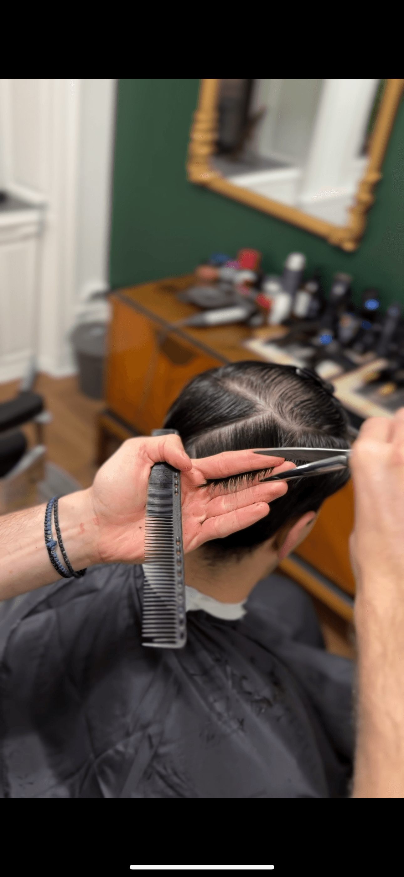 Client's hair being styled by a barber