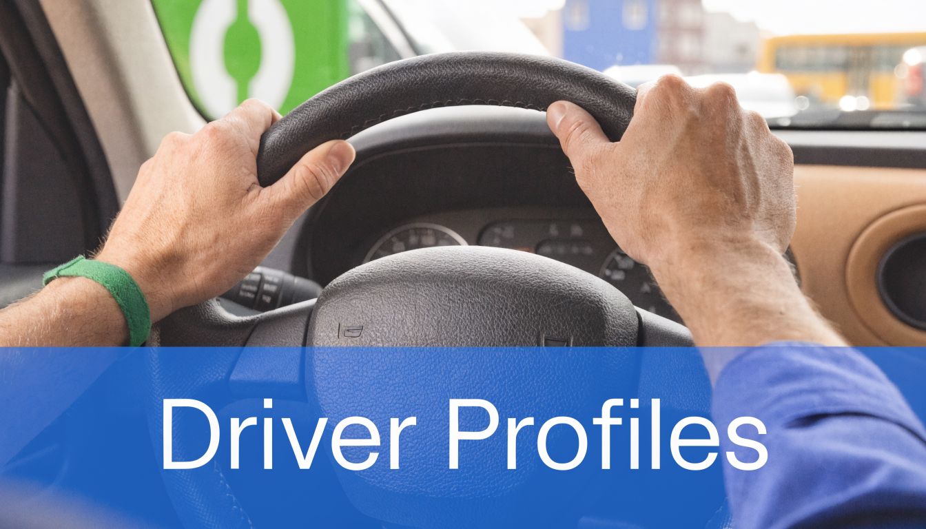 A first-person perspective view of a driver with both hands on the steering wheel while driving.