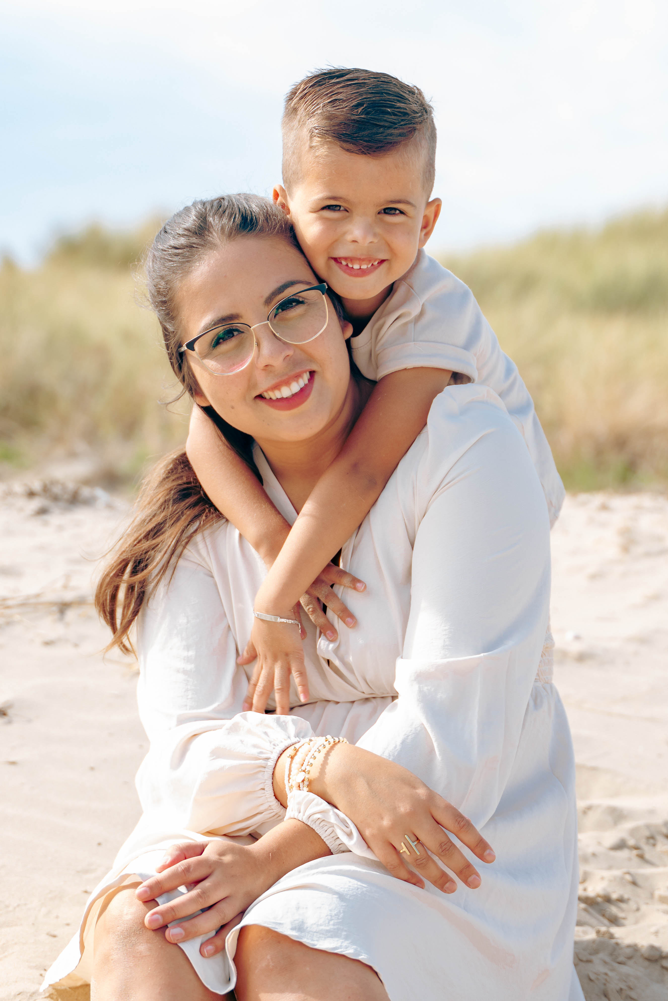 A couple embraces lovingly on a wooden dock.