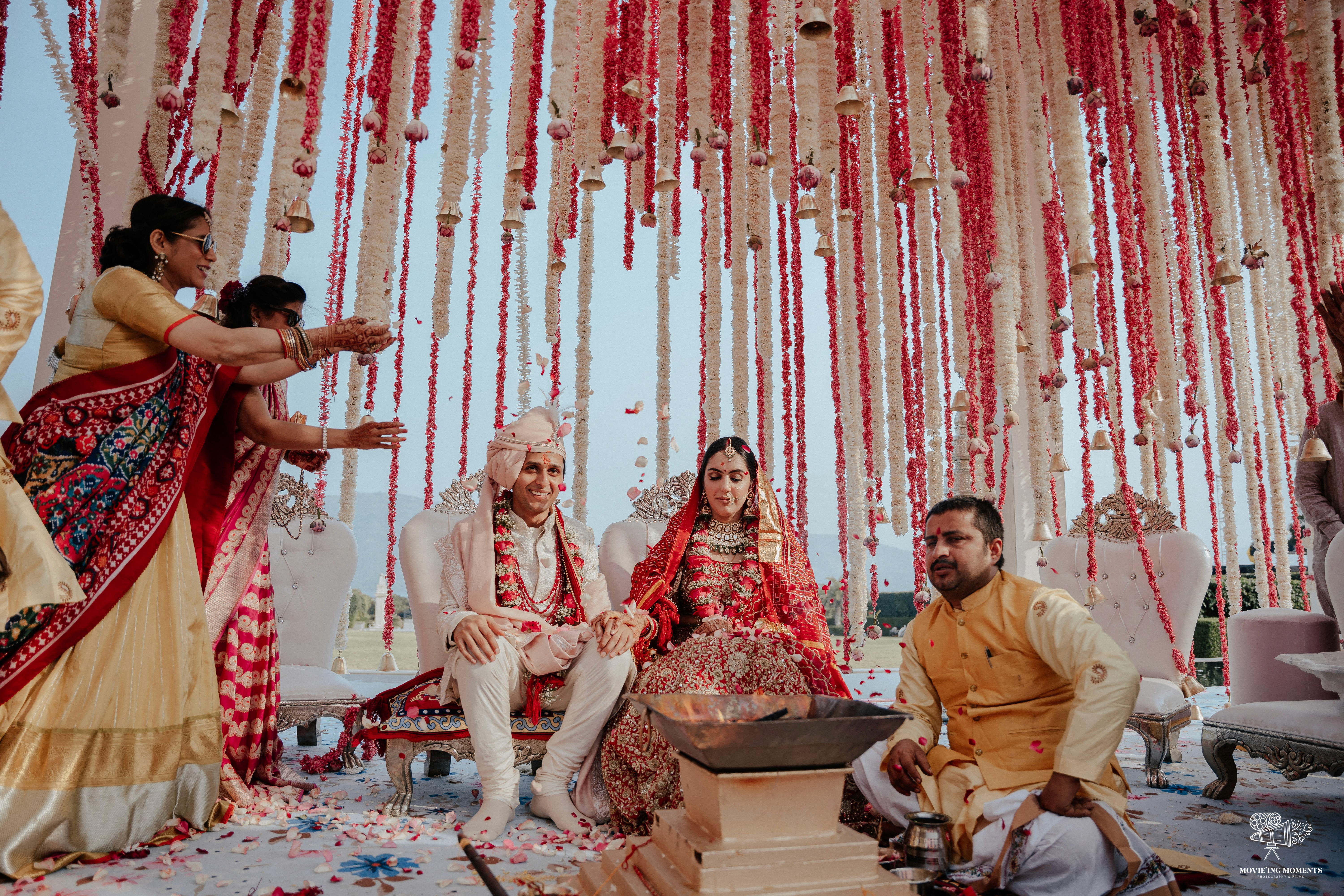 people sitting on chair under red and white floral umbrella