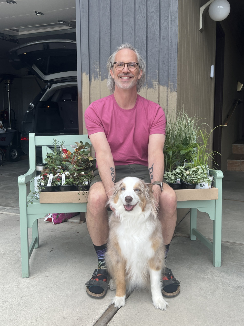Jamey Baumgardt at home with his Australian Shepherd Indie