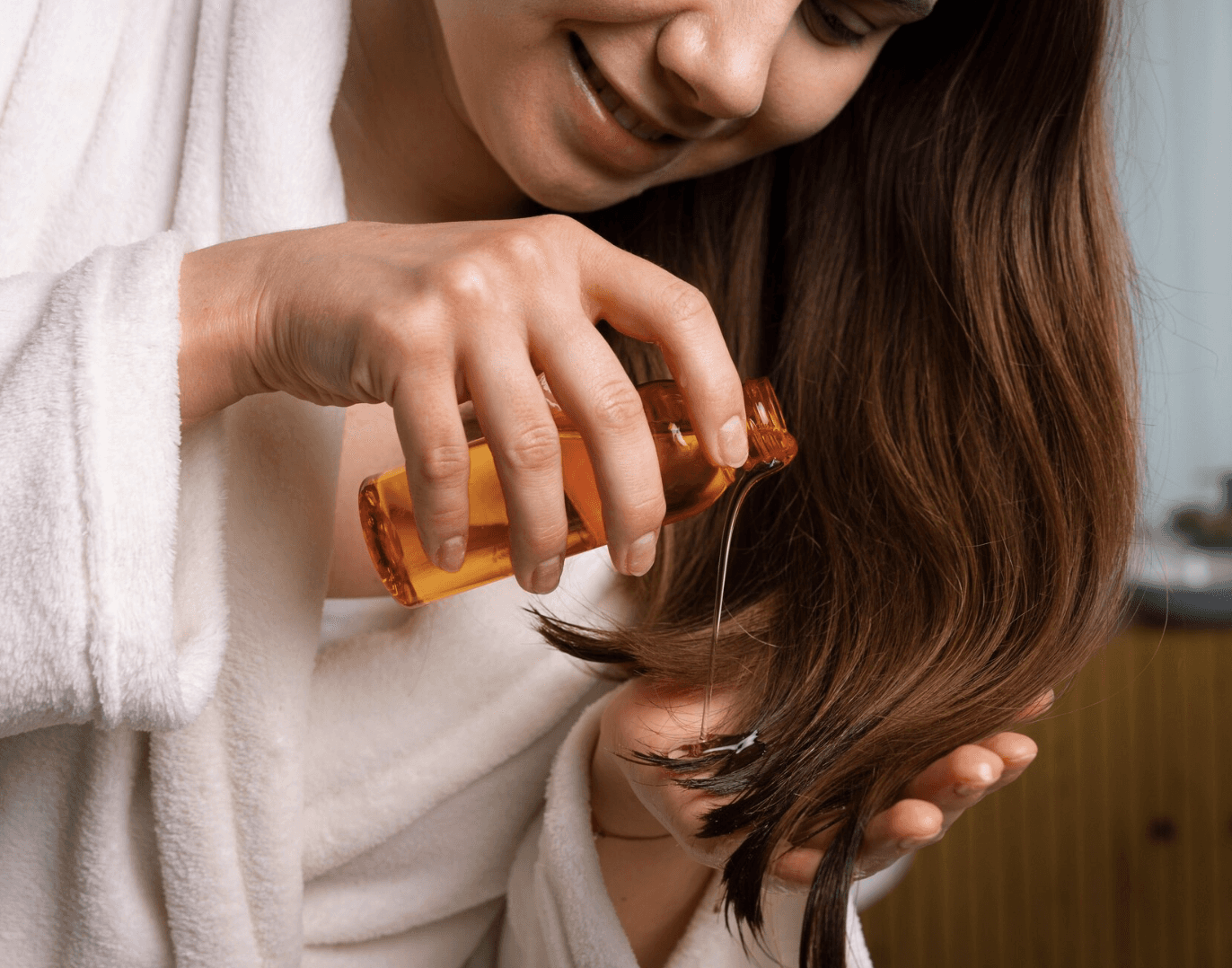 woman applying nourishing hair oil