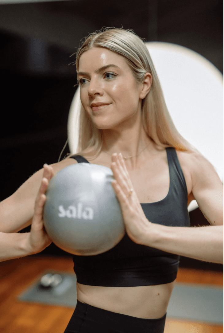 Black cosmetic product bottle against a dark background