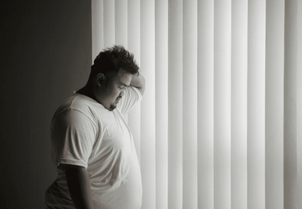 man experiencing depression highlighting the link between mental health and physical wellbeing