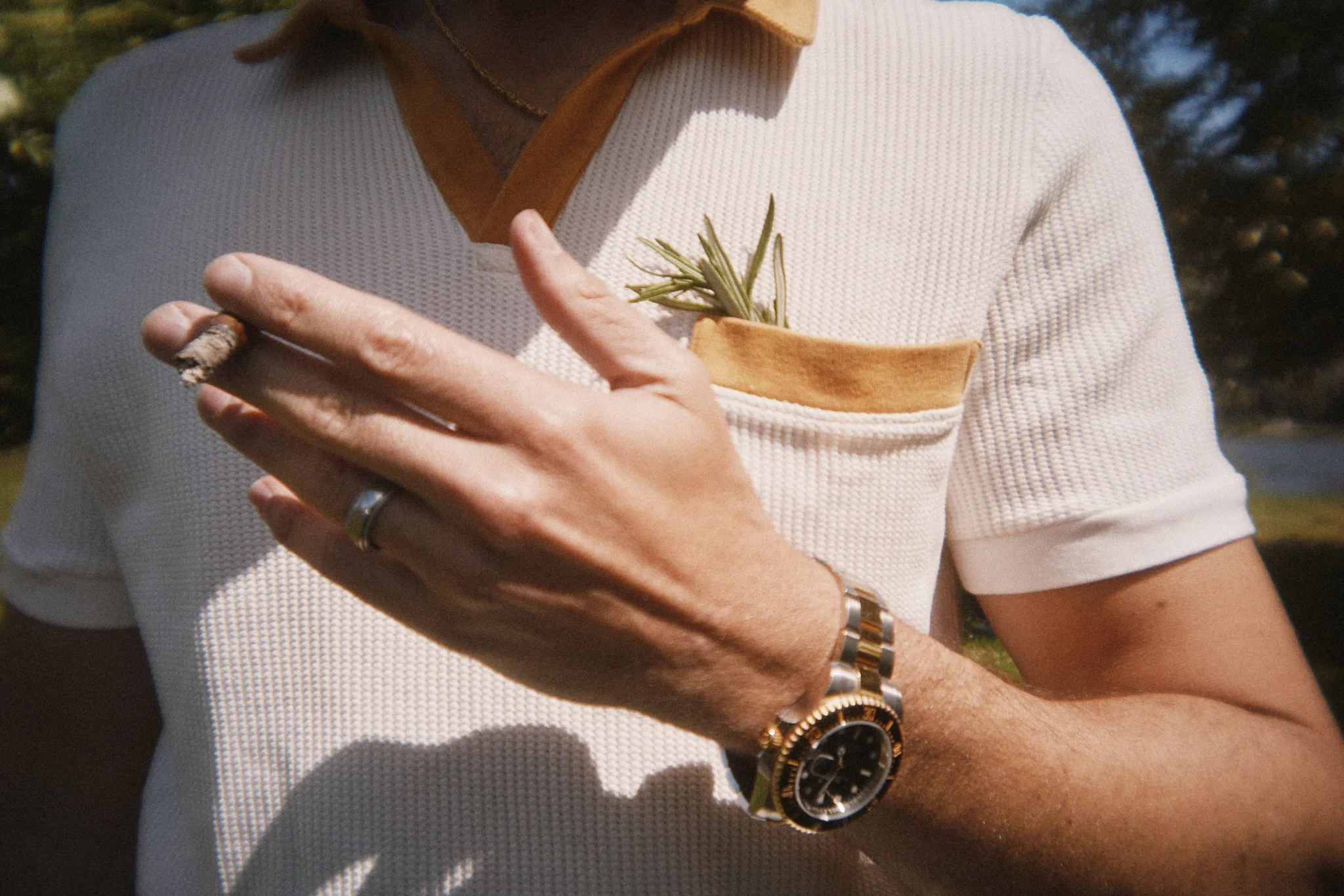cigar between fingers sprig in pocket — lifestyle photography by Tom Kubik