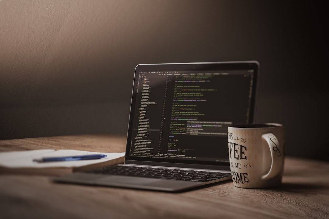 Laptop screen displaying code with coffee mug.