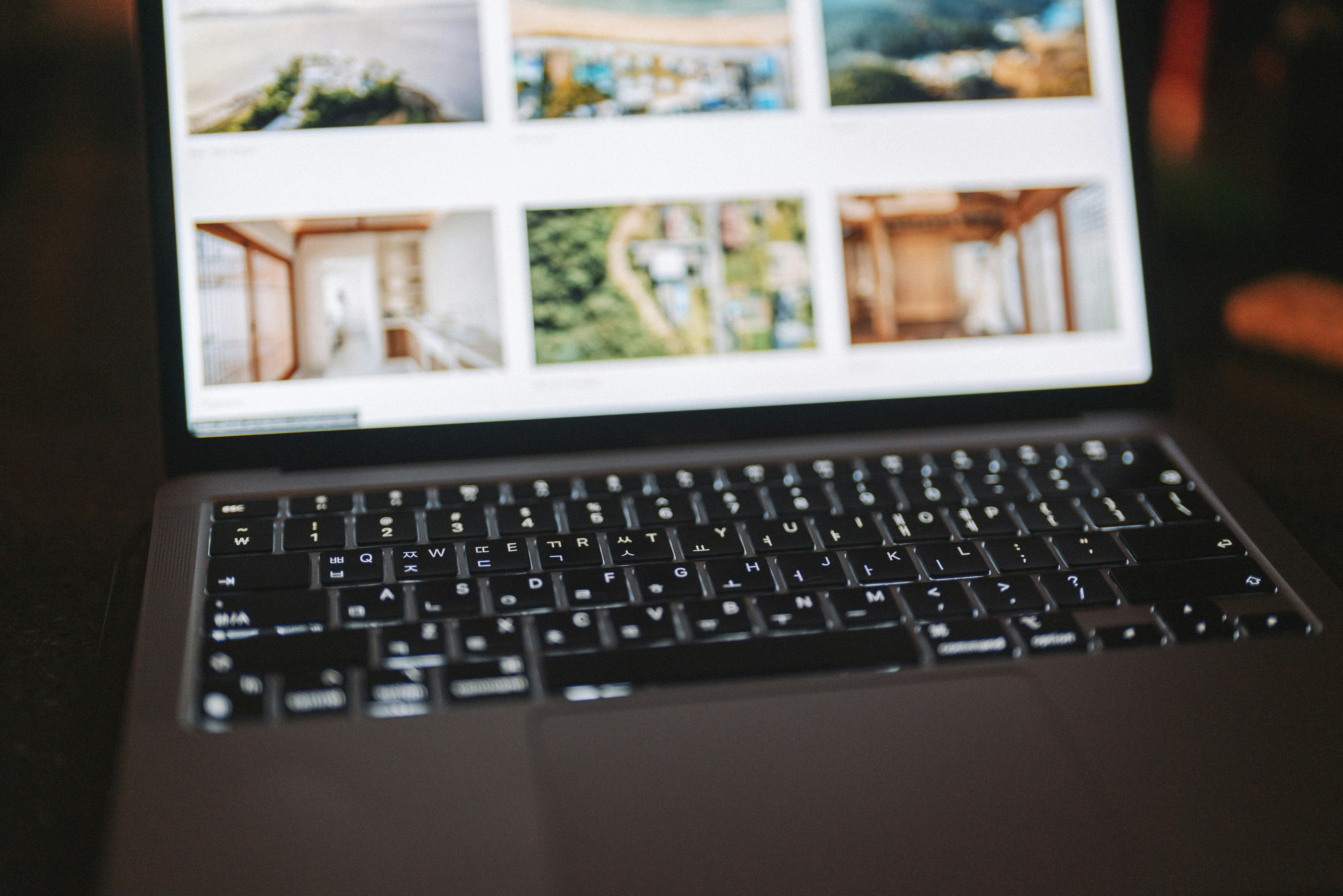 Laptop displaying a grid of real estate listing photos