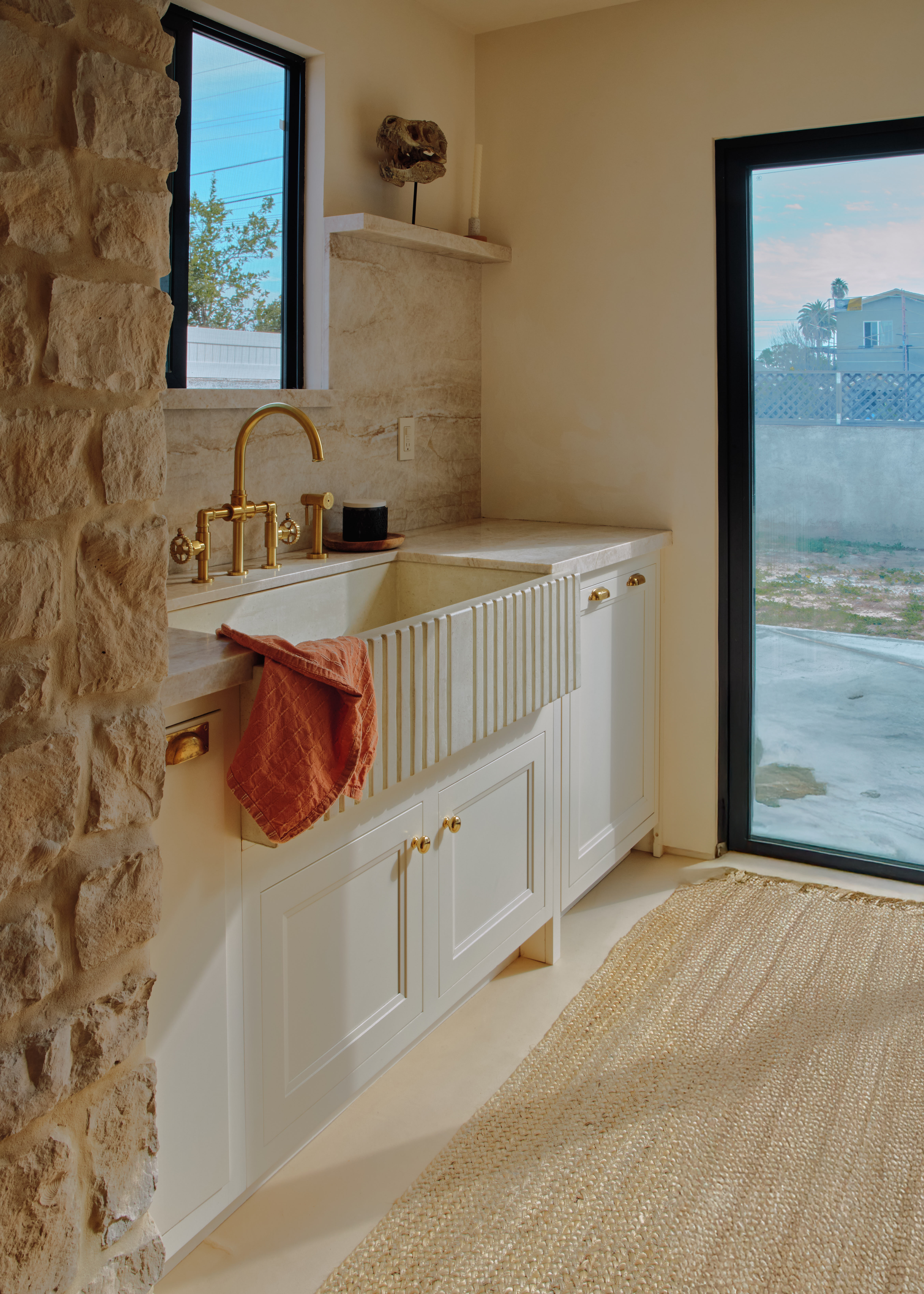 Young woman with dark hair and bangs, wearing red.