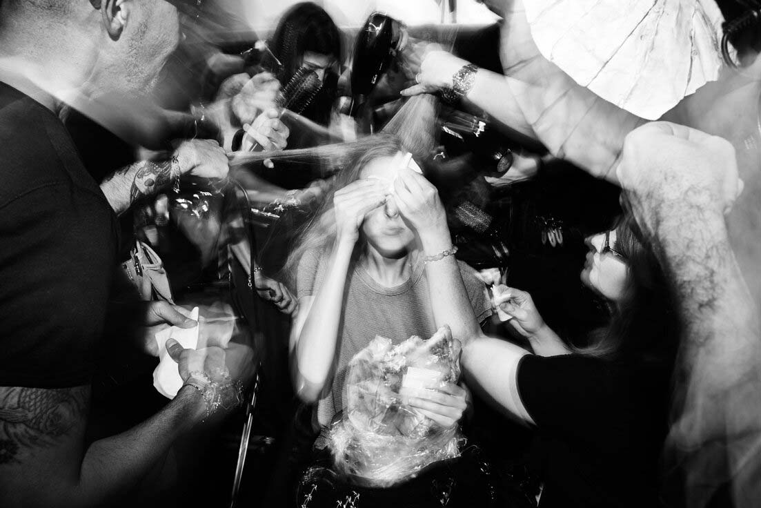 A fast black sports car races down the highway.