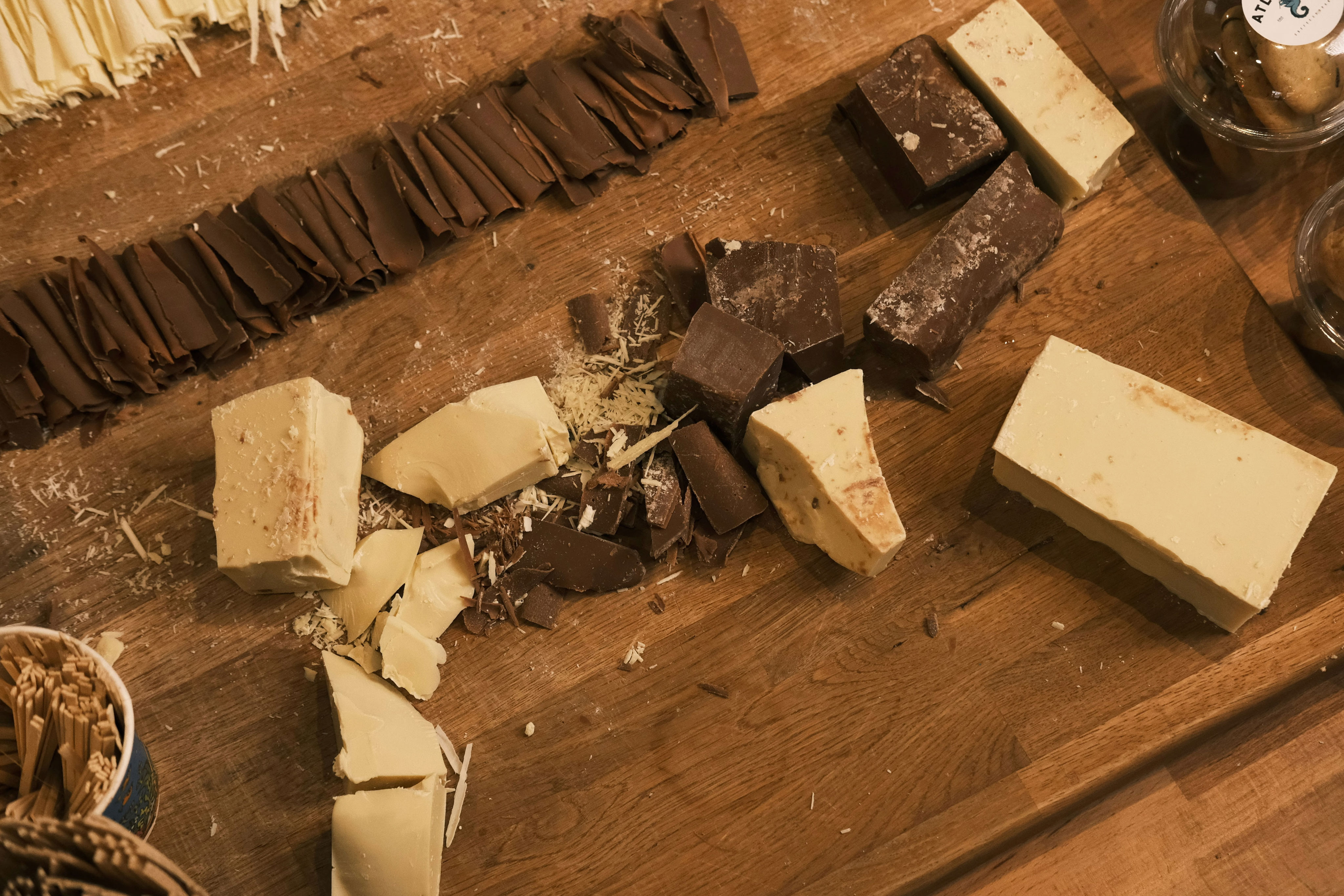 A wooden table topped with lots of different types of cheese