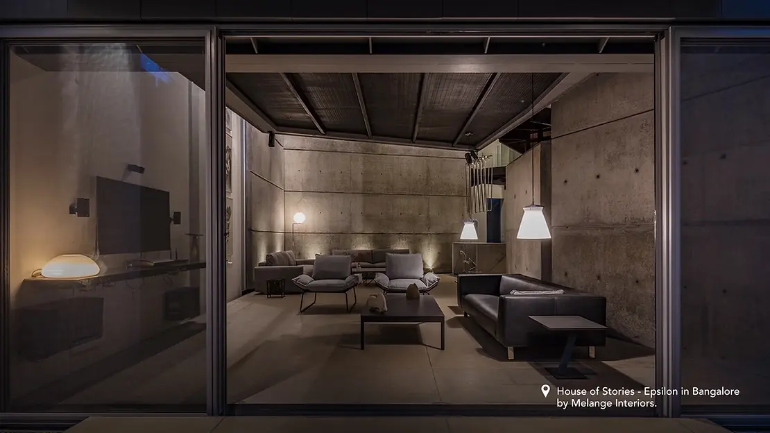 A modern dark living room interior design style, featuring furniture and a large glass door.