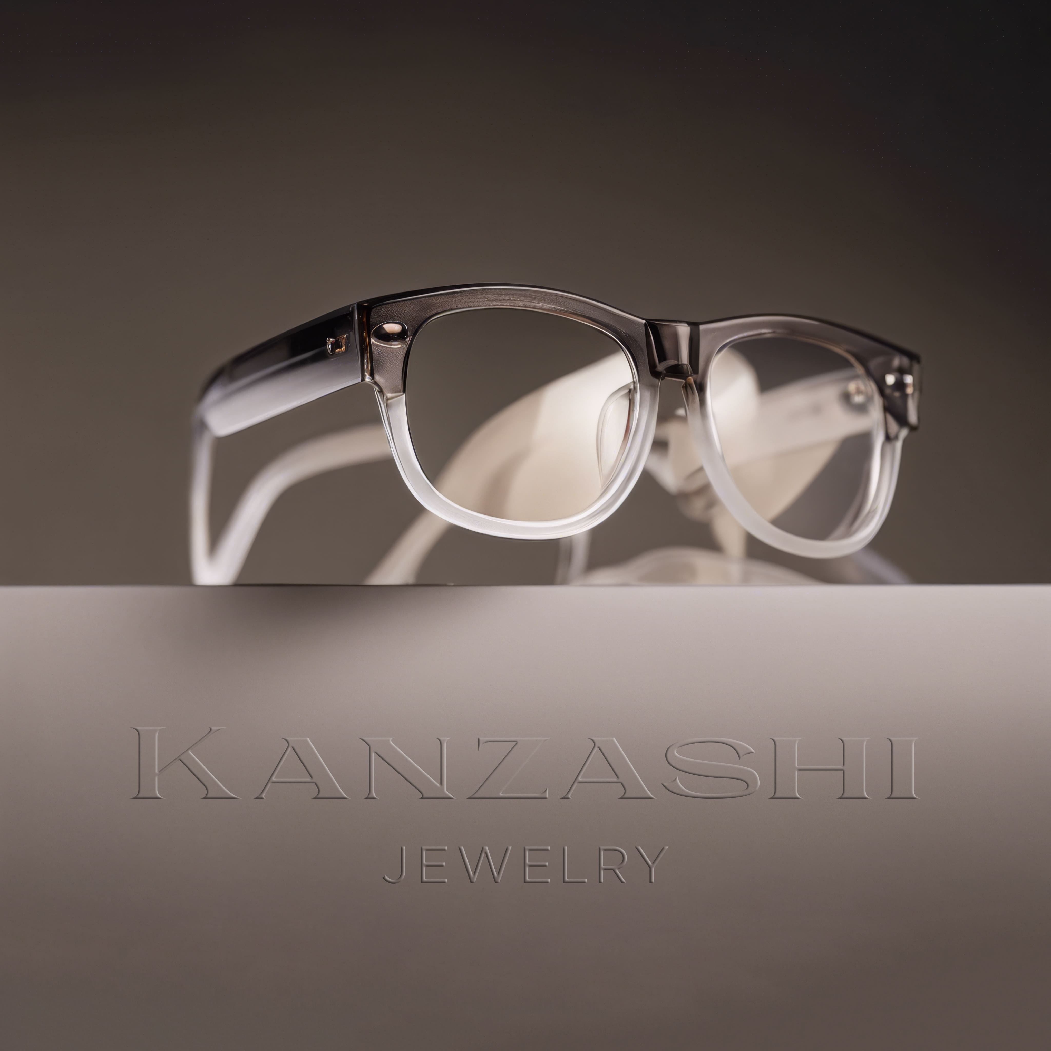 A pair of stylish glasses with clear and dark-tinted frames rests atop a sleek, reflective surface. The frame features a modern design with a polished metallic accent. Beneath the glasses, the word KANZASHI is elegantly embossed, accompanied by the word JEWELRY, creating a sophisticated presentation against a muted background.