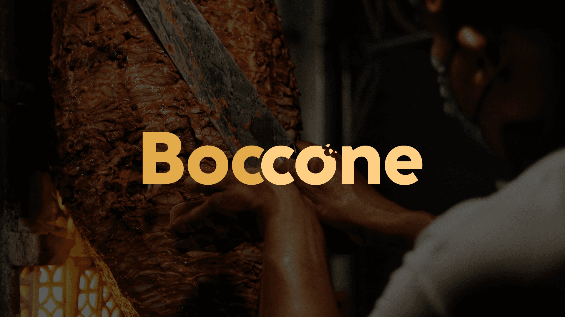 Chef slicing roasted shawarma meat with the Boccone Café logo displayed in bold across the center.