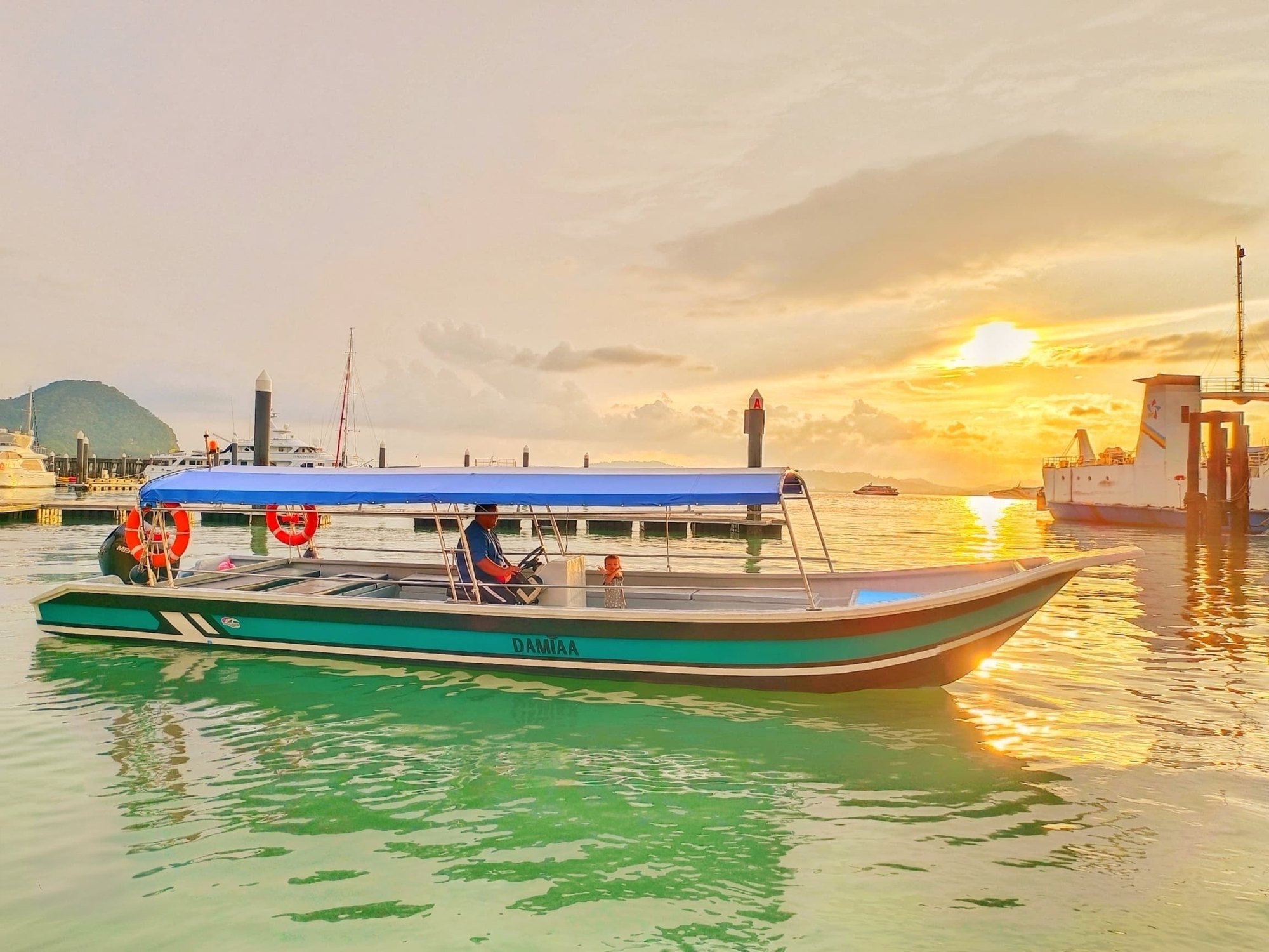 The island hopping speedboat at the jetty at sunset