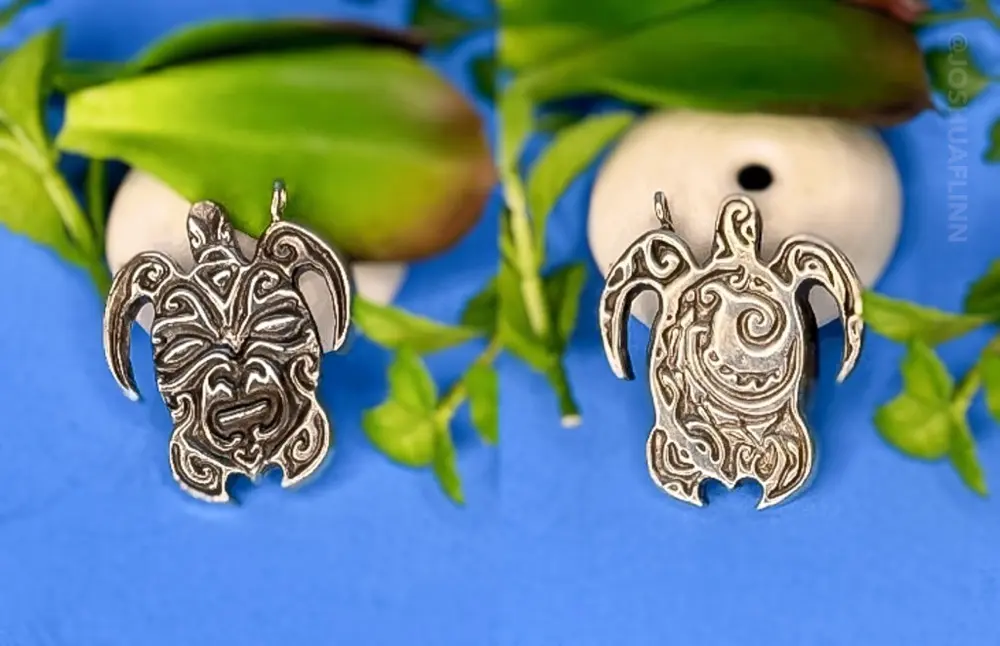 closeup of a silver cast polynesian sea turtle honu pendant