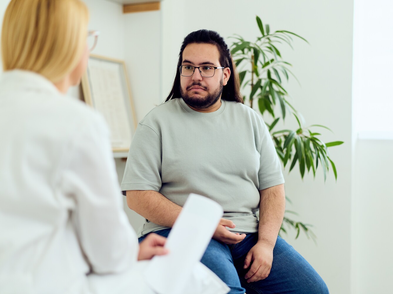 overweight man in a doctor’s appointment to discuss results from Zepbound weight loss medication
