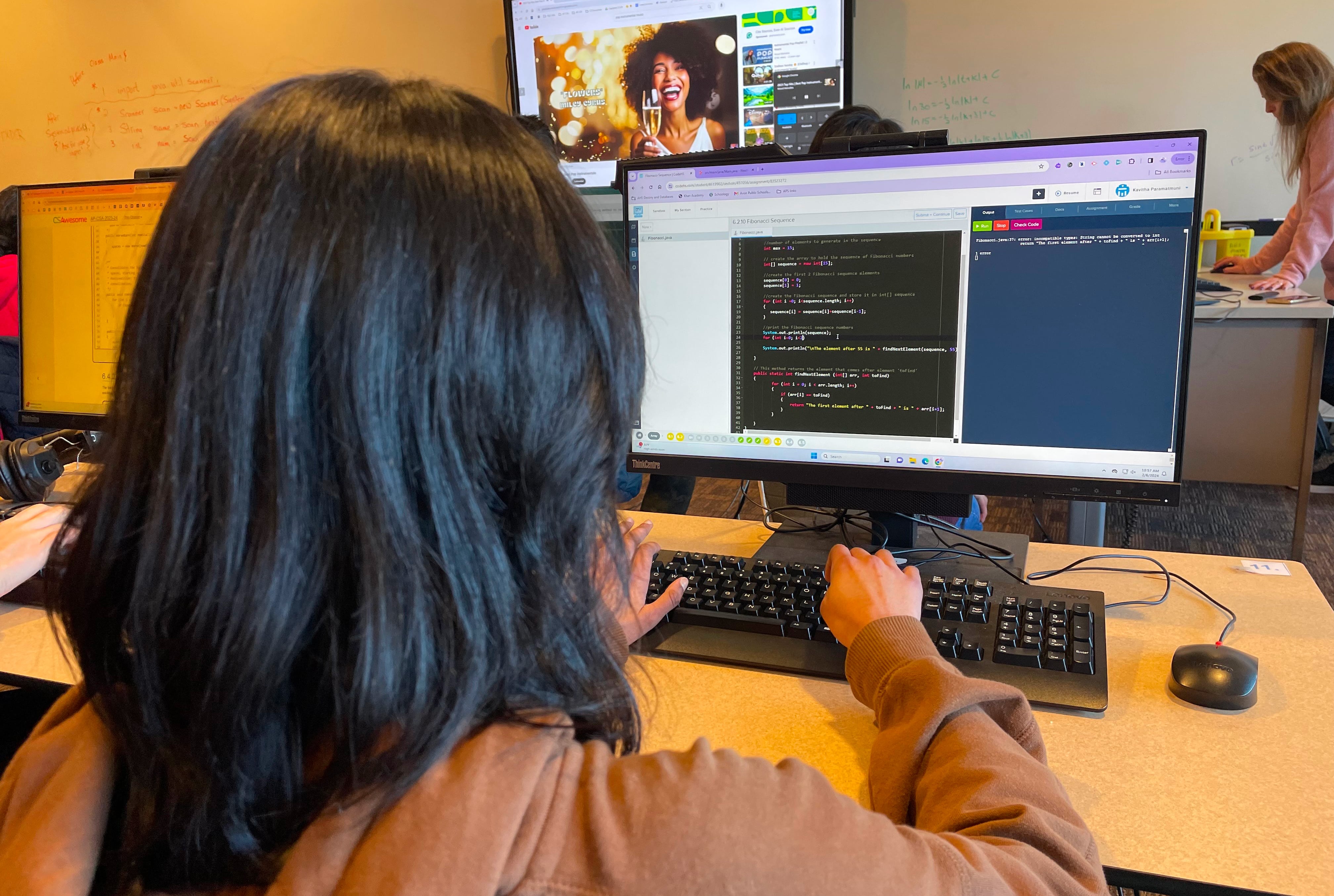 Kavitha programming on her laptop