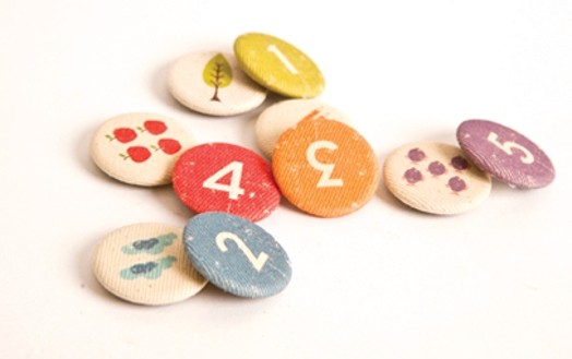 Buttons with fabric covers and different icons, like food, people, signs, etc.
