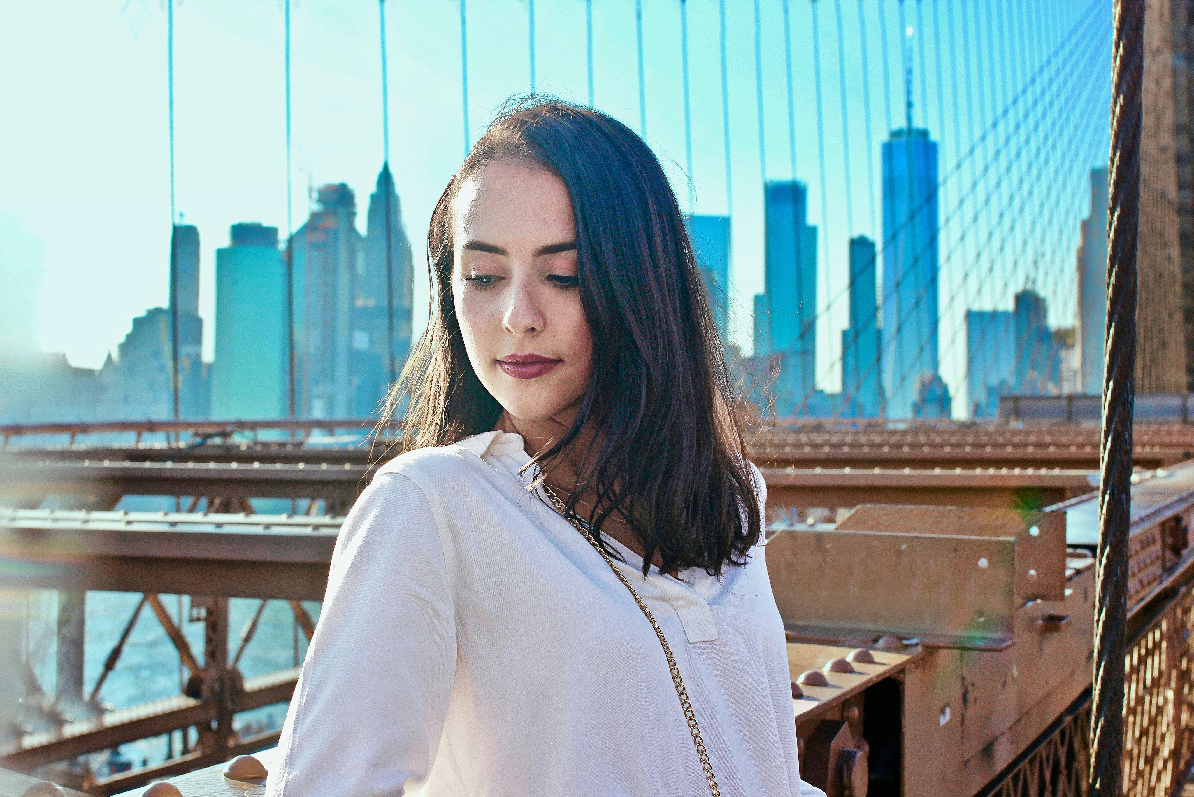 woman standing on a bridge - Colors For Summer Skin Tone