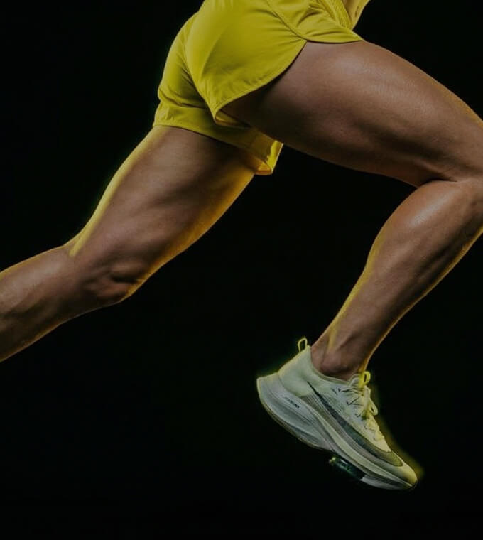 Close-up of an athlete's legs mid-stride while running