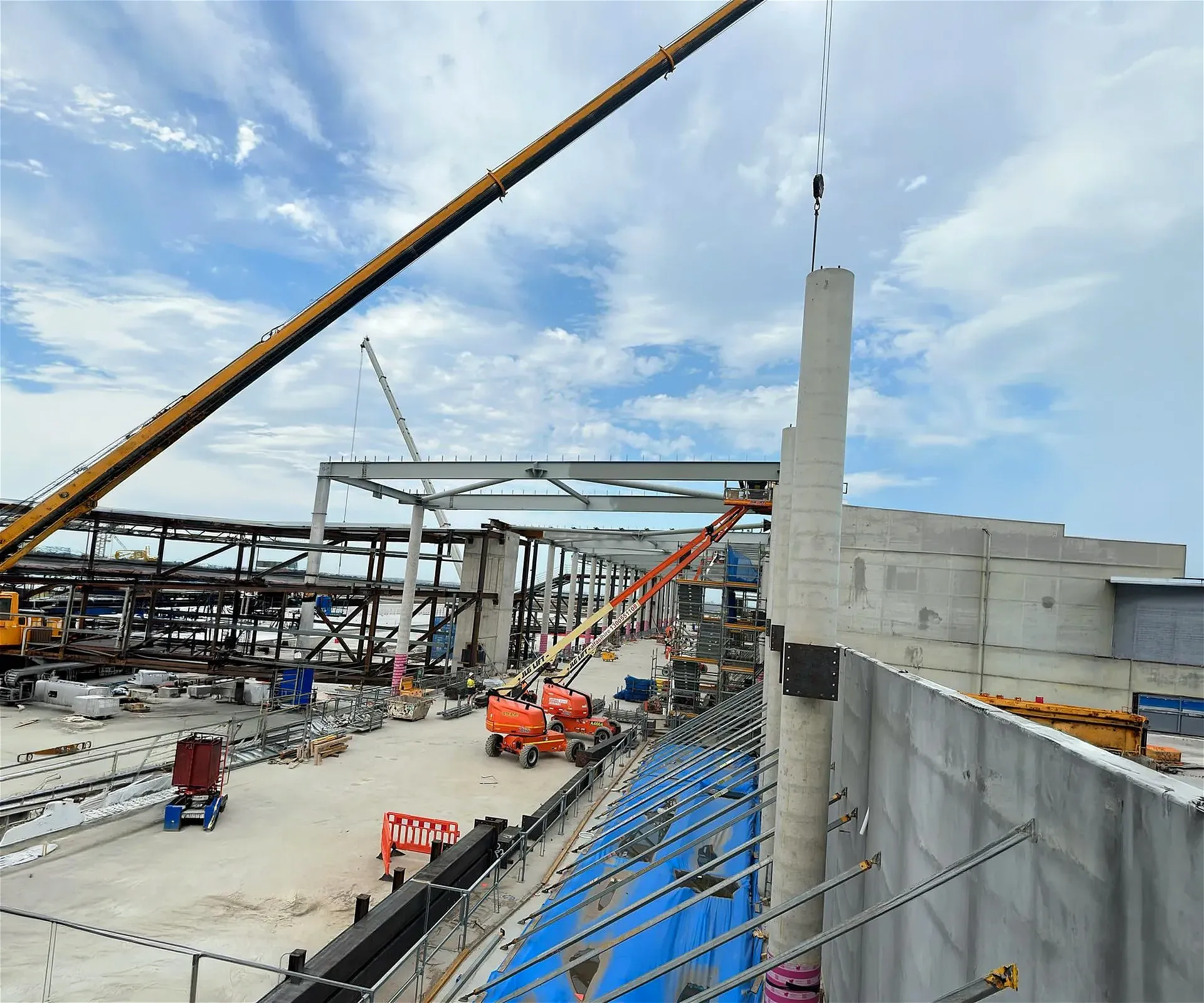 Construction site with cranes and lifts.