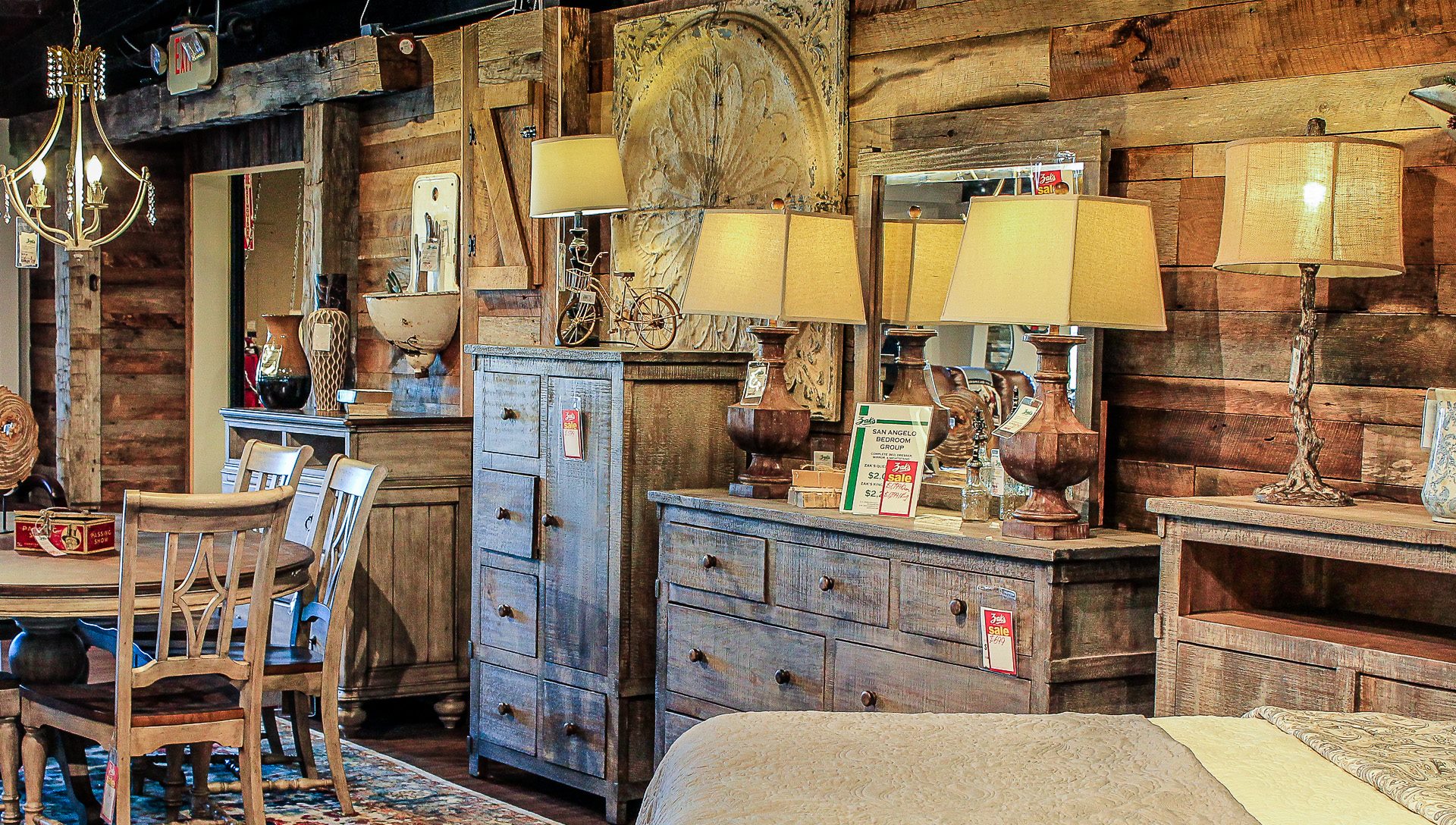 Showroom interior with displays of furniture, lamps, art work and other home decor items.