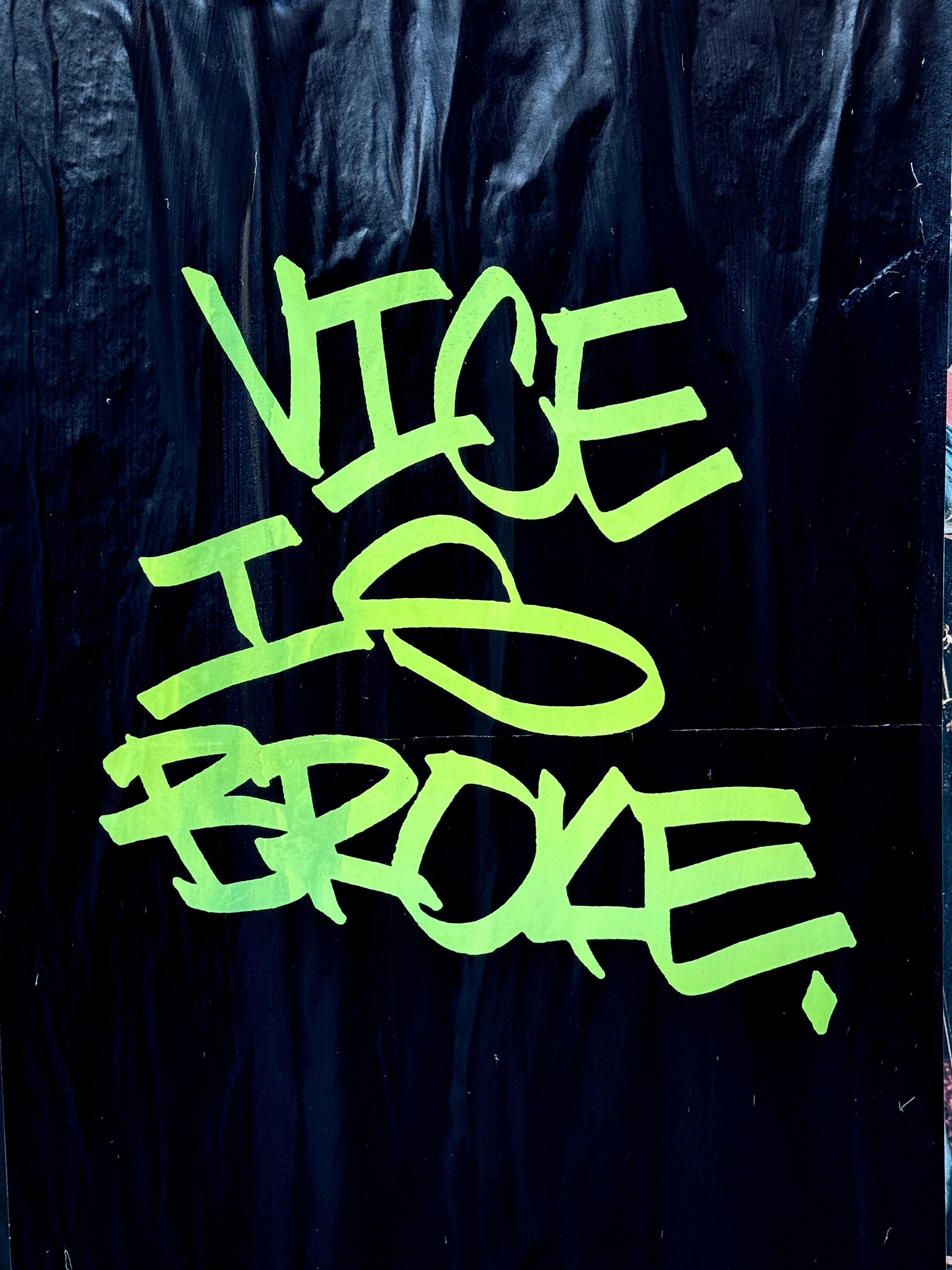 Neon green graffiti on black surface