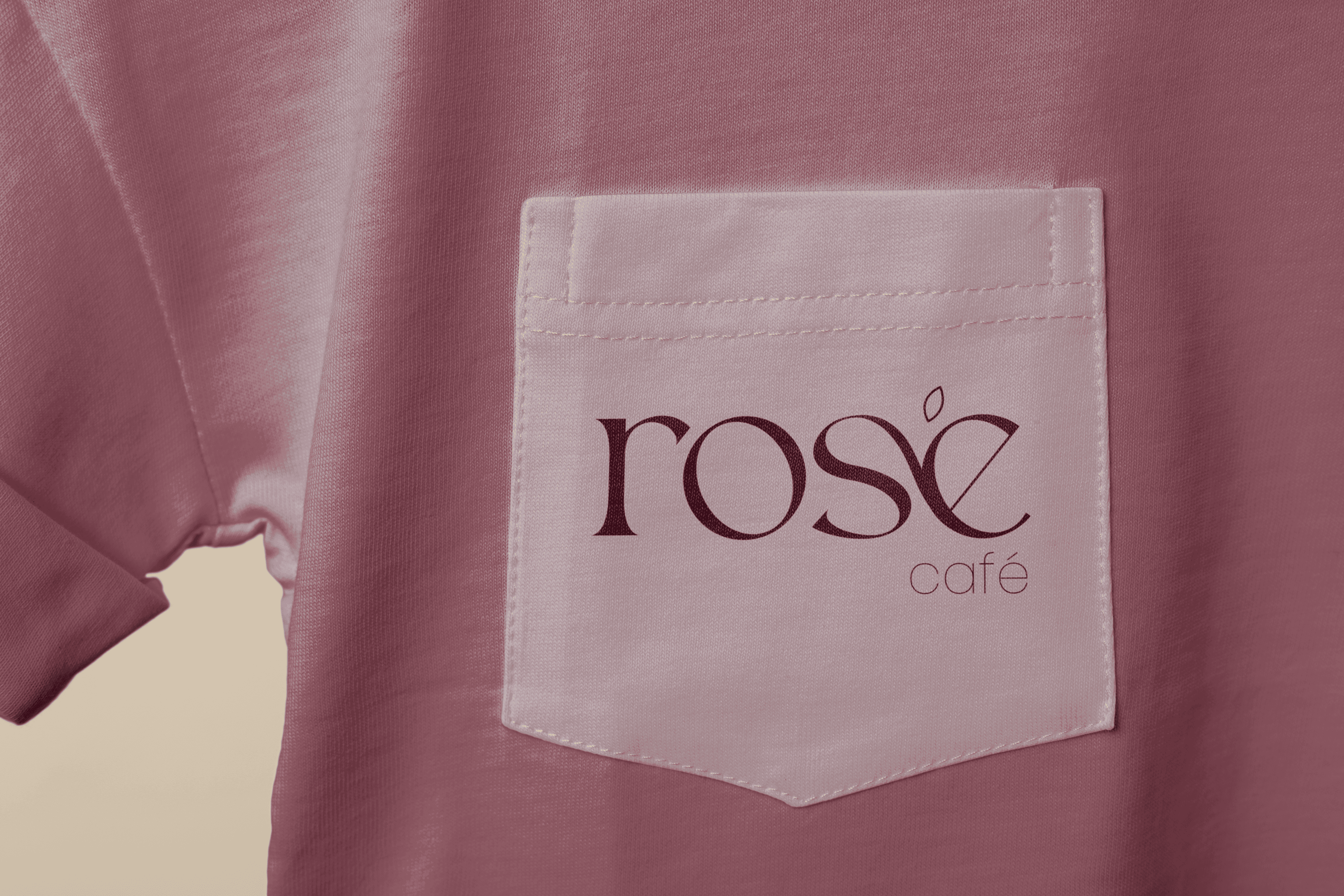 Rosé Café logo on pink pocket tee close-up